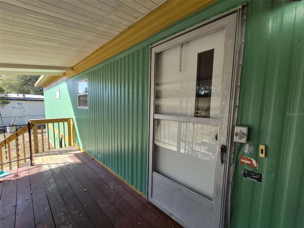 Photo of 18565 SE 24th Lane, Ocklawaha, FL 32179 (MLS # OM718806)