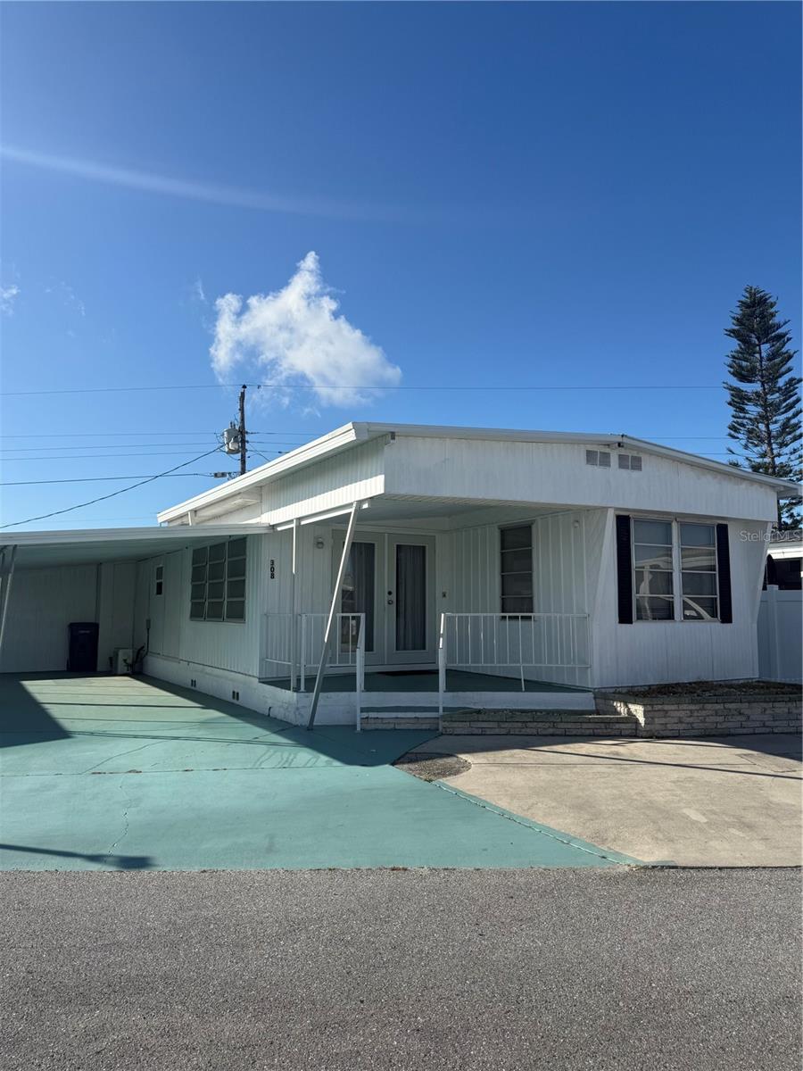 Affordable Florida Living with Expansion Potential!
Discover the perfect blend of comfort, convenience, and opportunity in this land-owned double-wide manufactured home. Featuring two bedrooms and one bath, this well-maintained home has stylish vinyl flooring throughout. The fenced backyard offers privacy and space for pets or outdoor enjoyment, while the enclosed lanai area is roughed in for an additional bathroom, bedroom, and living space, providing excellent potential for customization. Designed for low-maintenance living, the home includes durable vinyl siding, newer roof and new Wall AC Unit and a utility shed for extra storage and convenience. Located in a pet-friendly community with a low $175/month HOA fee, residents enjoy amenities such as water, sewer, trash, a heated community pool, shuffleboard, and a recreation hall. Ideally situated near shopping, dining, entertainment, public transportation, and just minutes from Florida’s beautiful beaches, this property is perfect for a full-time residence, vacation getaway, or investment opportunity. Don’t miss out—schedule your showing today!