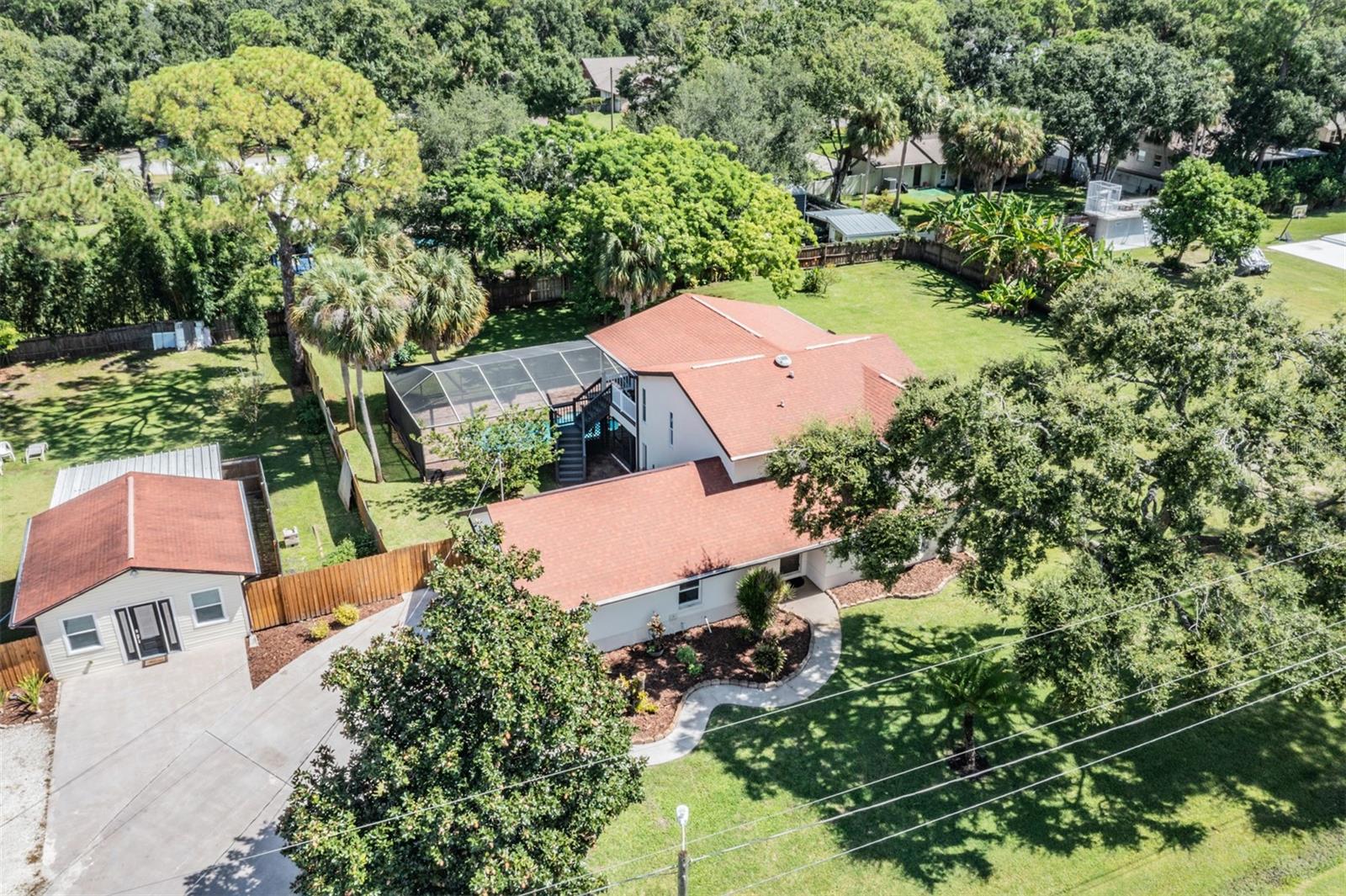 Gorgeously remodeled and updated in a prime location!!! This stunning fully furnished and equipped Florida pool residency provides the perfect oasis for entertaining friends and family or as an investment opportunity as a short-term rental. Uniquely positioned on a spacious double lot— a very rare to find in Tampa! The home boasts immediate curb appeal with an expansive backyard - large enough for a shed, man cave, plenty of space to add a garden or playground. Double fence access for additional storage of boats, RVs, and jet skis. This amazing home features 4 bedrooms with 2.5 bathrooms and has an attached 2 cars garage equipped with a Tesla charger hookup. From the moment you step inside, you will notice the extensive updates that have been made. The home is spacious with a great layout for those of you who like a split concept. The primary bedroom with en-suite bathroom offers room for a king-size bed, a waking closet and an outdoor balcony seating area. The master suite is connected to a stunning spa-like bath that will make you feel like you’ve transported to a 5-star resort with the beautiful travertine walls and floors. Beyond the master suite lies three additional bedrooms. Freshly paint interior and exterior, luxury vinyl flooring throughout, updated bathrooms, light fixtures, recessed lighting, ceiling fans and much MORE. There is an eat in kitchen area for family get together with a kitchen island with pendent lights. The fully equipped kitchen and spacious dining area comfortably seat eight, perfect for entertaining or hosting guests. This beautifully furnished home features contemporary design throughout, creating a welcoming and stylish atmosphere. In addition, this home has a versatile layout, with the fifth bedroom functioning as an complete guesthouse, with a kitchenette, its own bathroom, and a separate entrance that is perfect for additional privacy for extended family members, guests, or as a dedicated rental unit. Continuing the resort-like feel, the screened in lanai area offers a quiet and pleasant space, the outdoor is a true oasis ideal for relaxation, your morning coffee while overlooking at the nice pool. or gatherings under the Florida sun. The spacious yard features sufficient area for your dogs, offering plenty of room for outdoor activities with your beloved pets. While located in flood zone, the property has never flooded, has remained powered through recent storms and flood insurance is notably affordable. Designed for both comfort and functionality, this property provides ample space for groups and families, making it an attractive option for short-term rentals or personal use. It has the meat and bones needed for a new buyer offering a private retreat while remaining conveniently close to the Tampa International airport, shopping centers, restaurants, beaches, and downtown Tampa. Schedule a showing today and experience the perfect combination of modern design, spacious living, and a prime location in the heart of Town 'n' Country! This home is more than a house; it's a lifestyle, blends luxury, security, and convenience—truly a unique gem in Tampa! Schedule your private showing TODAY! Listing agent is one of the property owners.