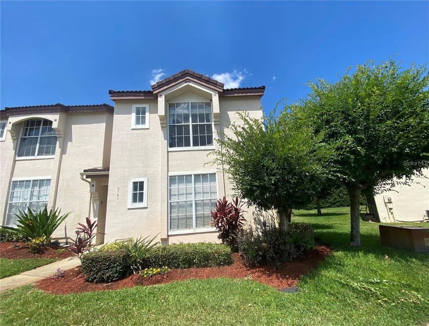 Discover this fully furnished, turn-key 2-story townhouse, offering a quiet, peaceful retreat just minutes from Disney. Located in a prime position within the subdivision, this 2-bedroom, 2-bathroom home features a versatile layout with a bedroom and bath on each floor, plus a cozy upstairs loft. The spacious living area boasts dramatic high ceilings, filled with light from twin, large glass sliding doors that open to a screened lanai overlooking a tranquil green space. Living here, you can enjoy a lifestyle with a public heated pool and spa, plus unbeatable convenience near Highway 192, Aldi, Publix, Target, and Walmart. Perfectly suited as a primary residence or high-performing investment, this charming property is truly a rare find