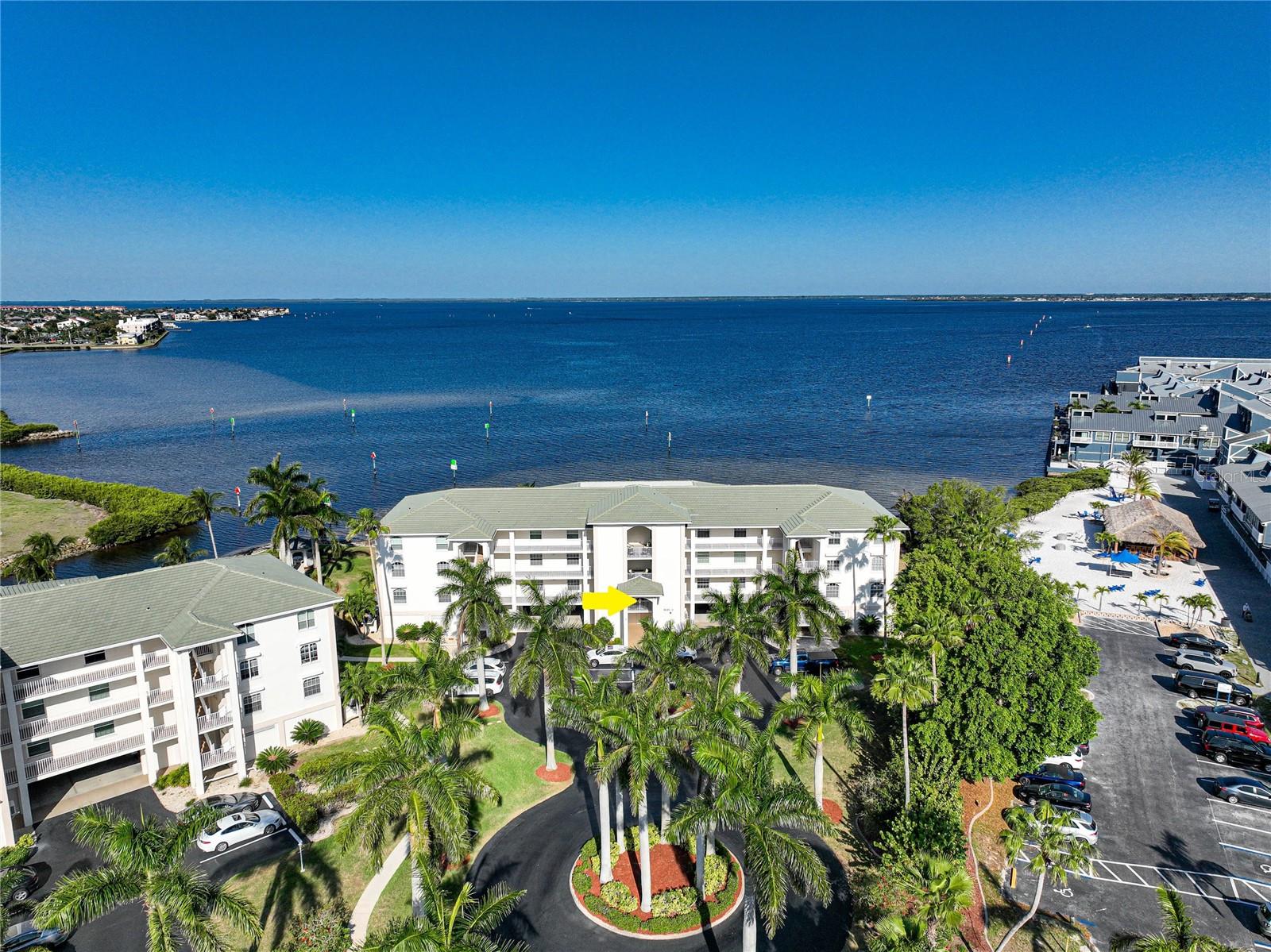 Experience unparalleled waterfront living in this beautiful 3 Bedroom, 2 Bathroom SECOND FLOOR Condo located in Punta Gorda Isles — where every day begins and ends with breathtaking water views. CLICK ON THE VIRTUAL TOUR LINK 1 FOR THE VIDEO AND VIRTUAL LINK 2 FOR THE 3D TOUR. Step inside to a bright and open living and dining area, ideal for entertaining family and friends while enjoying panoramic views of the harbor through the large sliding glass doors. The functional kitchen offers stainless steel appliances, solid surface countertops, a pantry, service window to the lanai, and a breakfast bar. The spacious master suite offers gorgeous harbor views, a walk-in closet, and an en suite bathroom with a dual sink vanity and walk-in shower. Guests will appreciate the split floor plan with two comfortable bedrooms, each with built-in closets and a shared guest bath. A large laundry room and extra storage make everyday living easy. The screened-in lanai is the perfect place to savor your morning coffee waterside or unwind in the evening with a front-row seat to stunning waterfront sunsets. Starboard Point offers under building parking with assigned storage rooms with amenities including a community pool, tennis courts, and fishing just steps from your door. All of this is within walking distance to Fishermen’s Village and historic downtown Punta Gorda, where you can explore waterfront dining, boutique shopping, and live entertainment. Schedule your showing TODAY!