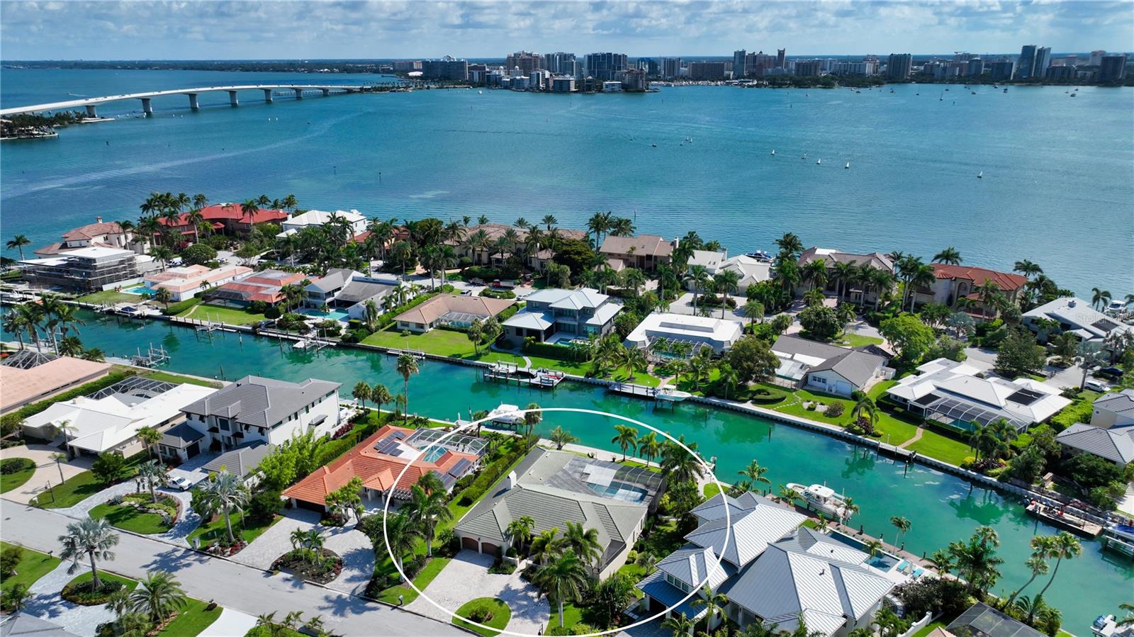 One or more photo(s) has been virtually staged. Welcome to this beautiful family home located in the desirable Bird Key neighborhood, in a prime position alongside calm and deep waters that flow out to Sarasota Bay. The inviting brick-pavered circular driveway and well-manicured landscaping create a warm and welcoming entrance to this family-friendly home, conveniently situated just a short distance from downtown. Spanning almost 3,300 square feet, the open and bright layout of this four-bedroom home is bathed in natural light. The foyer features exquisite etched glass, setting a sophisticated tone. The interior design includes a dedicated dining room and generously sized living room with pocketing sliders, seamlessly connecting the indoor and outdoor spaces, perfect for embracing the Florida lifestyle. Numerous updates have been made to enhance the home, including an updated HVAC system installed in 2021, a newer roof from 2006, impact windows and sliders (remaining non-impact glass equipped with storm shutters), crown molding, and oversized diagonal tile flooring. The upgraded eat-in kitchen, just steps away from the formal dining area, overlooks the family room, making it a breeze to entertain guests. With modern stainless-steel appliances, black granite countertops, a complementing backsplash, neutral cabinetry, built-in planning desk, and a wine cooler, this gourmet kitchen is as functional as it is stylish. Several rooms feature floor-to-ceiling impact glass sliders that lead out to the screened lanai, creating a seamless flow between the indoors and outdoors while filling the home with abundant natural light. Privacy is ensured with the split bedroom plan, making it ideal for overnight visitors. The master suite serves as a serene retreat, offering its own access to the waterfront lanai. The protected pool deck boasts a covered dining area and oversized swimming pool, perfect for relaxing or entertaining. Custom-designed brick pavers guide you to the deep-water boat dock and lift (which has been converted to a flat, kayak lift). Bird Key is renowned as one of Sarasota's most coveted bayfront communities, centrally located just minutes away from downtown, St. Armands Circle, Lido, Longboat, and Siesta Keys. From your front door, you can easily access the Bird Key Yacht Club, offering exclusive club access (for additional fees), a fitness center, tennis courts, swimming facilities, and additional boat dockage. For outdoor enthusiasts, the bayfront Bird Key Park is just a bike ride away, where you can participate in waterside yoga classes, kayaking, and an array of other activities. Indulge in the splendor of this exceptional family home, where its idyllic setting, lovely updates, and proximity to numerous amenities combine to offer a truly desirable coastal lifestyle.
