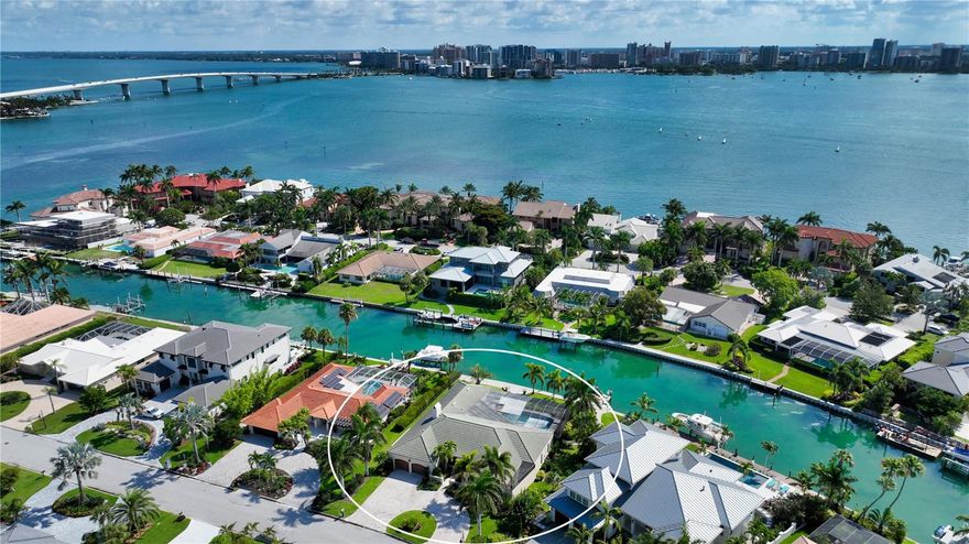 One or more photo(s) has been virtually staged.  Welcome to this beautiful family home located in the desirable Bird Key neighborhood, in a prime position alongside calm and deep waters that flow out to Sarasota Bay. The inviting brick-pavered circular driveway and well-manicured landscaping create a warm and welcoming entrance to this family-friendly home, conveniently situated just a short distance from downtown. Spanning almost 3,300 square feet, the open and bright layout of this four-bedroom home is bathed in natural light. The foyer features exquisite etched glass, setting a sophisticated tone. The interior design includes a dedicated dining room and generously sized living room with pocketing sliders, seamlessly connecting the indoor and outdoor spaces, perfect for embracing the Florida lifestyle. Numerous updates have been made to enhance the home, including an updated HVAC system installed in 2021, a newer roof from 2006, impact windows and sliders (remaining non-impact glass equipped with storm shutters), crown molding, and oversized diagonal tile flooring. The upgraded eat-in kitchen, just steps away from the formal dining area, overlooks the family room, making it a breeze to entertain guests. With modern stainless-steel appliances, black granite countertops, a complementing backsplash, neutral cabinetry, built-in planning desk, and a wine cooler, this gourmet kitchen is as functional as it is stylish. Several rooms feature floor-to-ceiling impact glass sliders that lead out to the screened lanai, creating a seamless flow between the indoors and outdoors while filling the home with abundant natural light. Privacy is ensured with the split bedroom plan, making it ideal for overnight visitors. The master suite serves as a serene retreat, offering its own access to the waterfront lanai. The protected pool deck boasts a covered dining area and oversized swimming pool, perfect for relaxing or entertaining. Custom-designed brick pavers guide you to the deep-water boat dock and lift (which has been converted to a flat, kayak lift). Bird Key is renowned as one of Sarasota's most coveted bayfront communities, centrally located just minutes away from downtown, St. Armands Circle, Lido, Longboat, and Siesta Keys. From your front door, you can easily access the Bird Key Yacht Club, offering exclusive club access (for additional fees), a fitness center, tennis courts, swimming facilities, and additional boat dockage. For outdoor enthusiasts, the bayfront Bird Key Park is just a bike ride away, where you can participate in waterside yoga classes, kayaking, and an array of other activities. Indulge in the splendor of this exceptional family home, where its idyllic setting, lovely updates, and proximity to numerous amenities combine to offer a truly desirable coastal lifestyle.