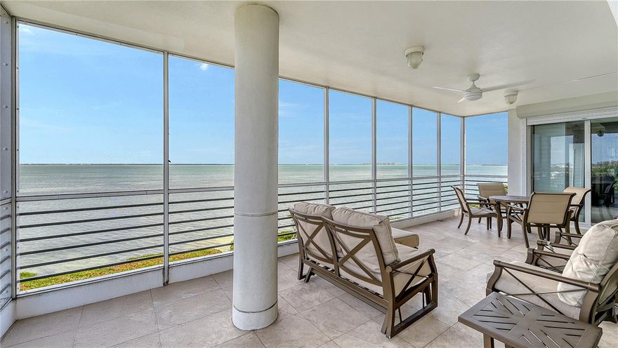 Located in a premier top-floor, corner position of Marina Bay II, this exceptional residence offers sweeping views of Sarasota Bay, the Harbourside Golf Course, and the dynamic city skyline beyond. With nearly 3,400 square feet of light-filled interiors, this three-bedroom residence lives like a single-family home—while offering the convenience and security of an exclusive, gated community within the Longboat Key Club. Double doors open from your private elevator landing into a gracious foyer that reveals a spacious, open-concept design, waiting for your personal touches. The interior is anchored by oversized windows and floor-to-ceiling sliders, framing the water views and bathing the home in natural light. Tasteful finishes include neutral tile flooring throughout, custom built-ins, and soft hues that create a relaxed and refined atmosphere. Recent updates include two new air-conditioning systems and new water heaters (2023). The heart of the home is a eat-in kitchen outfitted with granite countertops, a central island, stainless-steel appliances, and abundant cabinetry. A sunny breakfast area and adjacent family room offer the ideal setting for casual gatherings. For more formal entertaining, a large dining area and an expansive living room provide ample spaces that flow seamlessly onto the bayfront terrace. This covered, screened outdoor lounge is the perfect spot to savor calming bay breezes. The primary suite is a tranquil retreat, offering panoramic water views, direct terrace access, dual walk-in closets, and en-suite bath with glass-enclosed shower and soaking tub. Two guest bedrooms, arranged in a thoughtful split layout, each feature their own en-suite baths, ensuring comfort and privacy for family and guests. Additional highlights include motorized storm shutters, ample storage, and two secure under-building parking spaces. Marina Bay is an intimate community of just 60 residences, where residents enjoy 24-hour gated entry, on-site management, a fitness center, tennis courts, barbecue grilling area, and a heated bayfront pool and spa with a scenic sundeck. Ownership behind the gates includes deeded access to the private Bay Isles Beach Club—a coveted amenity with gated parking, beachfront pavilions, restrooms, and direct access to the white sands of Longboat Key. This prime location places you minutes from St. Armands Circle’s boutiques and restaurants, the cultural venues of downtown Sarasota, and world-renowned Gulf beaches. Live the waterfront lifestyle with every luxury at your fingertips.