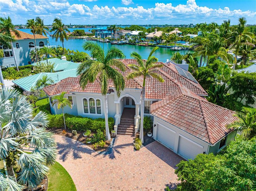 $200,000 price reduction. Waterfront Lido Key home within walking distance to charming St Armands Circle and the prestine shores of Lido Beach. Situated on the serene street of Cleveland Drive, this home faces south and resides on the widest sailboat and deep vessel water canal on Lido Key. This custom Arthur Rutenberg home also features 3 bedrooms, 3 bathrooms, 1 office, a private pool, an observation deck, and a newer, privately deeded dock with a 13,000 lbs lift—ideal for boat enthusiasts. From the expansive indoor and outdoor living spaces, soak in breathtaking panoramic water views. Entertain seamlessly on the patio, featuring an outdoor kitchen with a natural gas grill, or on the spacious upper observation deck. Experience tranquility and witness wildlife while kayaking through the South Lido mangroves. After the short paddle home, cool off in your outdoor shower or private pool & spa, both just steps away from the water's edge. The exceptional water views can be enjoyed from the master suite sitting area. The master suite provides privacy, dual bathrooms including an Italian walk-in shower, high ceilings and private access to the paver brick veranda. Owned solar panels and newly installed generator offer sustainability and peace of mind. This is truly a rare and incredible opportunity to purchase a 0.34 acre/ near 15,000 square feet lot with canal frontage on Lido Key. This location is walkable to St Armands with its many restaurants and boutiques, and the beautiful Lido Beach Sunsets. Bring your boat and live the Lido Key lifestyle.