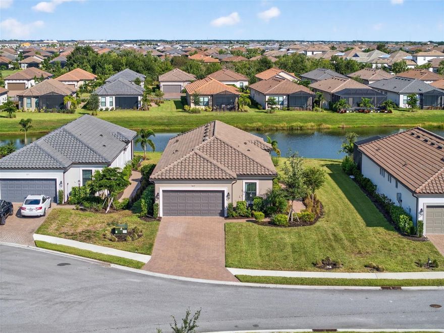 Experience modern luxury and effortless sophistication in this stunning golf-deeded home, located in the highly sought-after community of Esplanade at Azario in Lakewood Ranch.

This beautifully designed 3-bedroom + flex space, 2-bathroom residence showcases Taylor Morrison’s highly desired Arezzo floor plan, blending modern comfort with refined architectural detail. The home sits on an oversized lot with an elongated driveway, offering both privacy and curb appeal just a short distance from the amenity center.

Inside, natural light fills the open-concept living area with highlighting tray ceilings, 8ft doors, designer tile and plush carpet flooring, and elegant finishes throughout. The chef-inspired kitchen features custom cabinetry, quartz countertops, a farmhouse sink, and a reverse osmosis, water purification, and softening system, ensuring every detail caters to both beauty and function.

Retreat to the luxurious primary suite featuring serene lake views, a spa-inspired bathroom with dual vanities, and a spacious walk-in shower. The flex room provides versatility—perfect for a home office, media room, or guest retreat.

Step through glass sliders to your screened lanai, where tranquil water views and lush landscaping create the perfect setting for morning coffee or evening gatherings. Additional upgrades include natural gas, a two-car garage, and maintenance-free living for ultimate peace of mind.

Beyond your doorstep, Azario’s resort-style amenities set the standard for luxury living—featuring a championship golf course, resort-style and lap pools, wellness spa, fitness center, tennis and pickleball courts, a culinary center, 3 restaurants additionally a cafe for your morning walk with coffee and a vibrant social calendar.

Ideally located within Lakewood Ranch—America’s #1 best-selling multigenerational community—you’re minutes from world-class beaches, dining, shopping, and entertainment at University Town Center, Waterside Place, and downtown Sarasota.