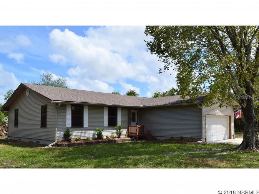 Under contract taking backups. Looking for an affordable place in the country yet close to shopping and the beaches? This western NSB location is a great choice. Updated inside and out, this home has a newly renovated kitchen w/ stainless steel appliances, upgraded bathrooms, wood laminate flooring and carpet throughout along with new paint inside. Large Fireplace adorns the eastern wall of the living room. Roof installed 2007. EZ care exterior vinyl siding. Ready to move you and your loved ones right in. Includes additional attached .46 +/- acre parcel and a large 2 car garage for motorcycles, ATVs or any other toys you may want out in the country. Plenty of room to roam and 10 minutes to shopping, I-95 and the beaches. 30 mins to Sanford. Perfect for first time buyers or retirees. Sold AS IS, inspections welcome.