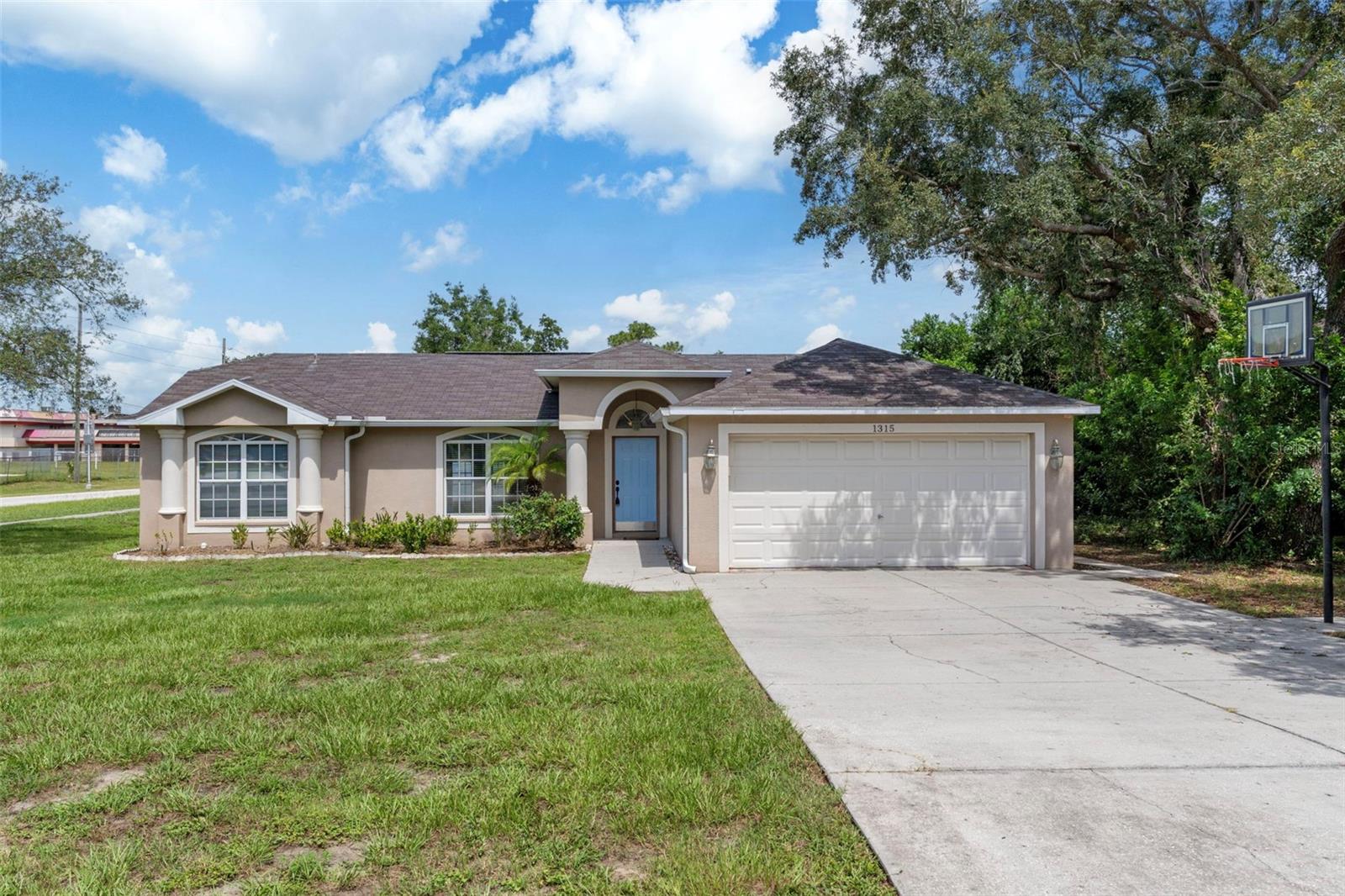 One or more photo(s) has been virtually staged. WELCOME HOME! This spacious and well-maintained 3-bedroom, 2-bathroom home is situated on a desirable corner lot in the heart of Spring Hill. Featuring a fully fenced-in backyard, back lanai, and a 2-car garage, this home offers comfort, privacy, and convenience—all just 10-15 minutes from a wide range of shopping, dining, and recreational activities. Step inside to discover a bright and open main living area where the living room, dining room, and kitchen flow seamlessly together, creating the perfect space for everyday living and entertaining. The kitchen is equipped with beautiful wood cabinets, granite countertops, stainless steel appliances, a breakfast bar, and an eat-in dining area. This thoughtfully designed split floor plan offers privacy for the primary suite, which includes a large walk-in closet, plush carpeting, a walk-in shower, and a relaxing built-in soaking tub. The two additional bedrooms are spacious and share a well-appointed guest bathroom with a tub/shower combo. French doors off the living area open to a screened-in lanai—ideal for enjoying Florida's beautiful weather year-round. Wood flooring runs throughout the main living areas and secondary bedrooms, and large windows throughout the home bring in abundant natural light. Don't miss out on the opportunity to make this home YOURS!