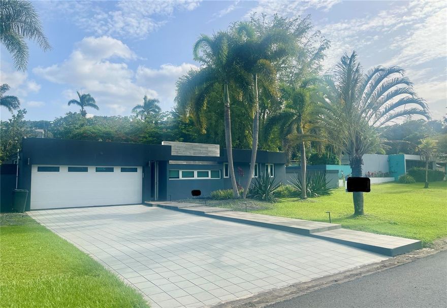 PRICED AT APPRAISED VALUE – LAKE VIEW! Exceptional Single-Level Estate in Controlled-Access Community - Welcome home to space, privacy, and breathtaking natural views! This spectacular single-level residence sits on a lush 1,991 SQM lot within a controlled-access community, offering a peaceful setting with beautiful lake and nature views—perfect for those who value tranquility without sacrificing convenience. The home features four (4) spacious bedrooms, three (3) full bathrooms, and two (2) half bathrooms, thoughtfully designed for comfortable living and entertaining. Enjoy separate living, family, and dining areas, plus a well-located laundry room near the kitchen with generous storage and pantry space.

Step outside to your private oasis: a 25’ x 27’ covered poolside terrace with outdoor kitchen, pool bath, and exterior shower, ideal for hosting unforgettable family gatherings and social events. The professionally landscaped grounds has ample room for tropical gardens and fruit trees, while two side entrances provide easy access for boat storage or added privacy throughout the fully enclosed property.

This impressive estate offers 3,130 SQFT of living area and approximately 6,000 SQFT of total construction, including: a covered terrace, two exterior concrete storage areas (10’x15’ and 6’x7’), a double garage with an extended carport, and multiple outdoor entertainment and utility spaces. Fully equipped for peace of mind, the property includes a fully redundant power generator, a large water cistern, a decorator kitchen, and appliances such as AC split units, ceiling fans, light fixtures, and security doors and windows. Centrally located on the border of San Juan and Caguas, this property offers quick and easy access from virtually anywhere on the island—location, lifestyle, and value all in one. A rare opportunity—priced at appraised value and ready to impress. Call today to coordinate your private VIP showing! PR MLS: PR9115292 - Thank you!