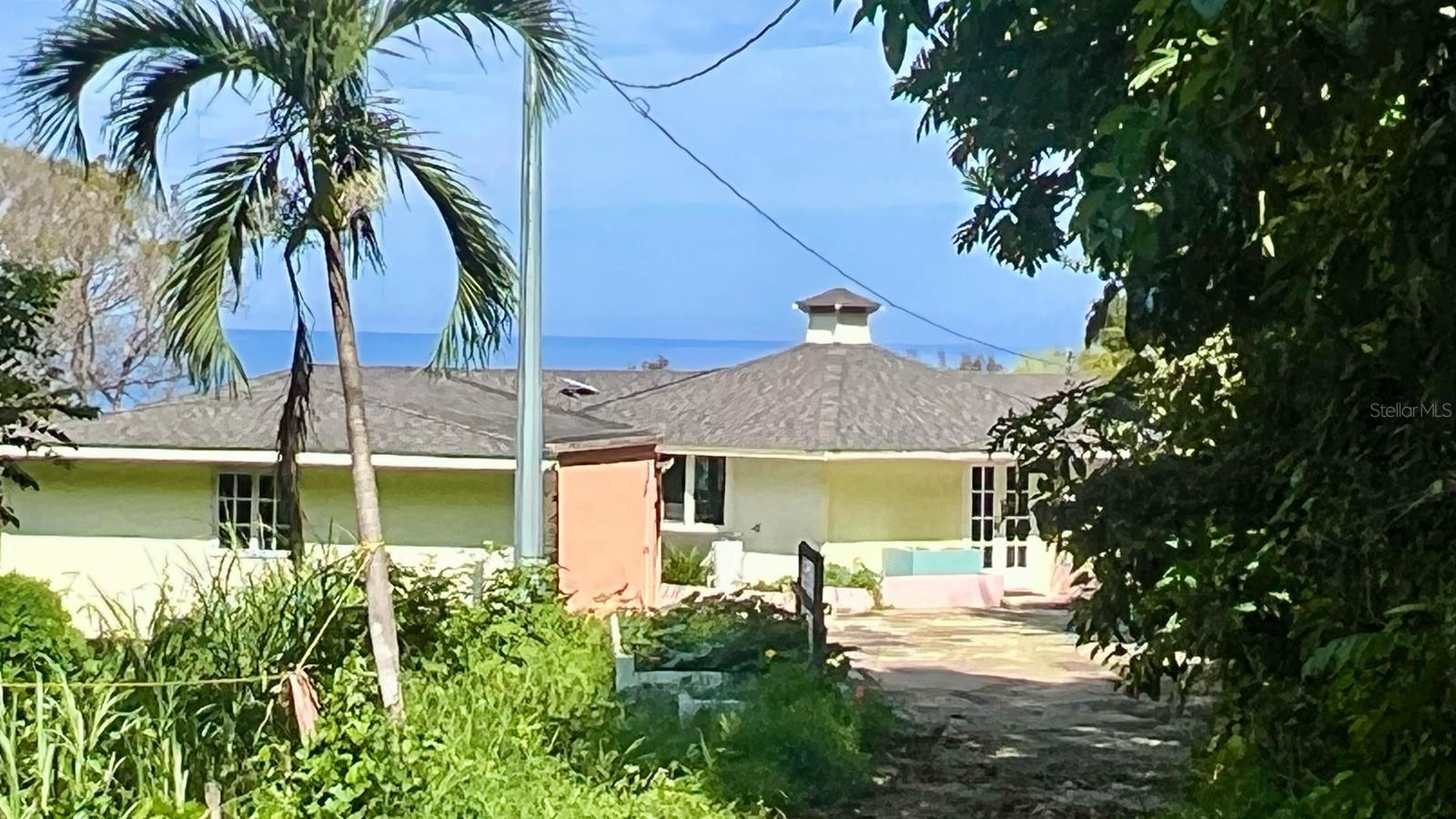 Paradise in dreamy dead-end road. Ocean, lighthouse, and dome views in Puntas, Rincón. Privacy with 2.614 acres connecting you to the Domes’ trail. Existing home with unique shape, concrete foundation and wood structure. 3/bd 2/ba, living/dining room, kitchen, balconies, and basement that can be built to expand. Call it home, second home or Airbnb. Chic minimalistic blueprints available from exclusive architect firm if you want to build in a peaceful environment blending luxury with Caribbean living.