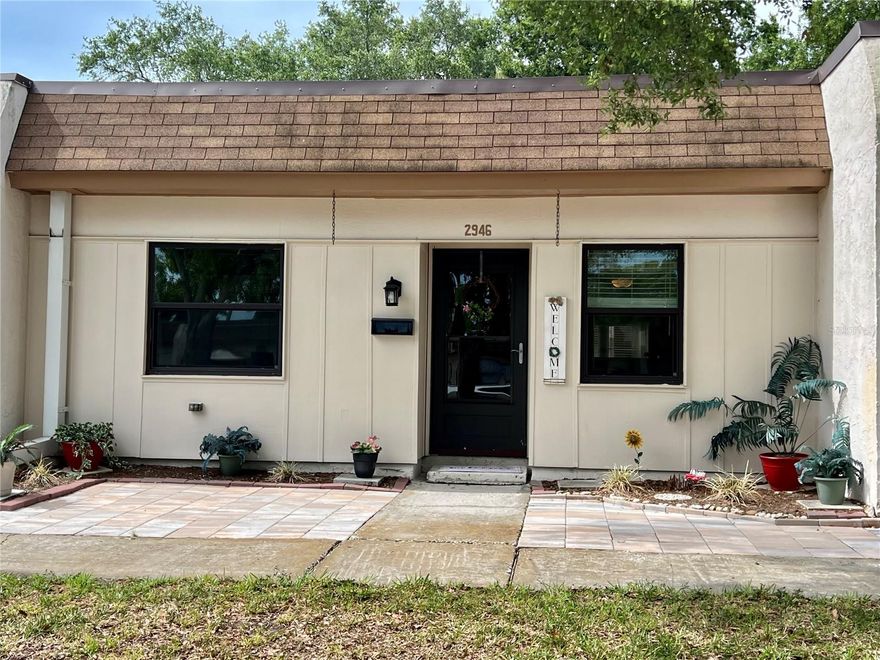 Welcome to the maintenance-free living in the highly coveted 55+ Mission Hills community! This charming 2-bedroom, 1-bathroom villa has been thoughtfully maintained with significant recent upgrades, ensuring comfort for years to come:• Brand New HVAC (2025) and Updated Electrical Box (2024). • New Appliances: Gas range (2025), kitchen faucet (2025), and a 2024 Whirlpool washer. • Modern Comforts: 2026 dining room and bedroom ceiling fans. • Location Security: Situated in a Non-Evacuation and Non-Flood Zone X—stay high and dry! Enjoy the sunshine on your choice of two beautiful new paver patios (2024). Whether you’re sipping morning coffee on the front patio or hosting a sunset dinner on the back patio, the outdoor spaces are designed for relaxation. The unit also includes a covered carport and an individual utility shed for extra storage. Convenience is at your doorstep. You are a mere 5-minute walk to Bayside Bridge Plaza (Publix, Planet Fitness, dining, and shopping). • Travel: 15 minutes to TPA and PIE airports. • Entertainment: 5 minutes to Safety Harbor, Ruth Eckerd Hall, and the Phillies Spring Training complex. • Leisure: 20 minutes to world-class beaches and 25 minutes to the energy of Downtown St. Pete. Mission Hills is famous for its lush, mature landscaping and vibrant social scene. The active Clubhouse offers a library, fitness equipment, billiards, and shuffleboard. Dive into the large heated community pool or join neighbors for bingo, ice cream socials, and planned excursions.