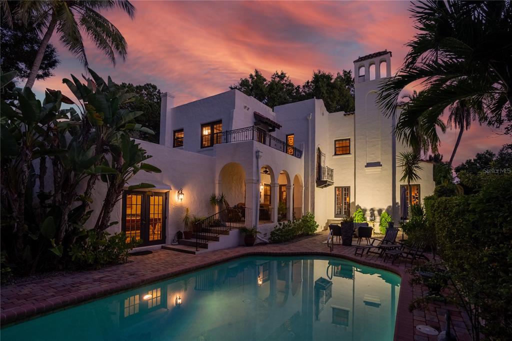 This grand estate, dubbed ’The Spanish Castle’ by acclaimed builder Samuel Schooley in 1920, is located on nearly a full acre in Old Pasadena. Old world walls, covered in creeping fig, encompass the stately gardens, pool and fountain courtyards, an alfresco dining area, 3 car garage, and gated parking, providing unabridged privacy. At the center of the estate is a historic 5,374 sf, 4 bedroom, 4 bath home where every detail has been meticulously maintained and upgraded to suit modern life. Upon entering the foyer, you’re welcomed with natural light flowing abundantly throughout the home. Timeless architectural details have been thoughtfully woven together with all of the modern-day amenities expected in a luxury home. Along with high beamed ceilings, arched windows and doors, crown moldings, and exceptional oak floors are a few little surprises; a vintage telephone room, an apothecary cabinet, and stained-glass accents which add to the charm this home exudes. Amongst the many modern upgrades are new AC systems, natural gas appliances, and custom Norman solar shades (partially motorized) installed throughout to improve energy efficiency. Entertain with ease from a formal living room with gas fireplace. Move into to the discerning tasting room with extensive wine storage, which flanks the formal dining room with original Cuban tile floors, chandeliers, and French doors. End your evening in the expansive billiards room with an antique wet bar, wood fireplace, and Saltillo tile floors. The newly remodeled kitchen, a masterpiece of design, offers both function and architectural consistency. The statement piece, an 1880’s draper’s table from a silk factory in Lyon France, serves as the island. The Viking appliance suite including a 48” range with grill, built-in refrigerator, and separate cold beverage storage. Custom cabinetry was fabricated with furniture trim finishes and is accented by Danby Marble countertops, hand-painted terracotta backsplash, and solid, unlacquered brass fixtures. It truly is a chef’s dream kitchen! The remarkable checkered floor is hand-quarried marble and limestone from France and leads to a landing area presenting ancillary cabinetry and a coffee bar. The expansive master suite comprises an entire wing and offers a private tea garden, wood-burning fireplace, his and her custom closets, and a large en suite bath. There is also access to a private balcony in the fountain courtyard. Located upstairs is the original master bedroom with wood-burning fireplace, 2 additional bedrooms, and 2 full baths. It’s the perfect split floor plan for families and also great guest accommodations. There are so many additional unique details to share, which only a private tour of this majestic home can reveal. Schedule your appointment today.