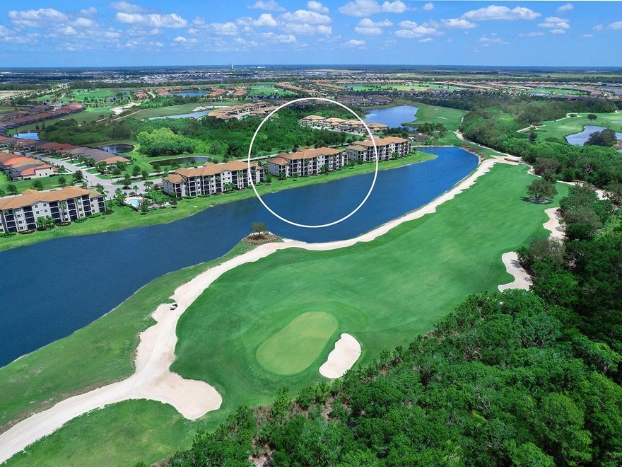 NOW JUST $275,000 FOR FURNISHED UNIT WITH GOLF MEMBERSHIP - AN AMAZING DEAL!  This one of the most AFFORDABLE CONDOS in Lakewood National and is offered FULLY FURNISHED and with full GOLF MEMBERSHIP for the larger size unit!  Don't miss this incredible opportunity!  Overlooking the 11th hole of the Commander golf course at Lakewood National, sits this charming and FURNISHED Birkdale floor plan condo.  With 2 bedrooms and 2 full bathrooms, and boasting both beautiful lake and serene golf course views, this unit is perfect for those looking to "right-size", for a seasonal home, or an investment opportunity with 30-day rentals allowed.  Included in your HOA dues is membership to Lakewood National, allowing you to take advantage of the resort-style amenities including two 18-hole championship golf courses, the Piper and Commander, both designed by Arnold Palmer.  Also included is access to the grand clubhouses, resort-style pool, 8 tennis courts, 4 pickleball courts, fitness center, spa, restaurant, and more.  You almost never need to leave the neighborhood!  This unit includes a covered carport parking space, and easy access via the stairs or building elevator to the second level which is perfectly positioned to take in the views.  The interior is graced by large format tile flooring, crown molding, an open floor plan, and impressive southern exposure views.  The great room is centrally located with remote-controlled blind and sliding glass doors to the private, screened in, paver balcony overlooking the lake and golf course.  The kitchen is outfitted with abundant solid wood cabinetry that reaches to the ceiling, 2024 rechargeable undercabinet lighting, central island with counter-height seating, granite counters, and stainless-steel appliance suite.  The dining room offers large bay-style windows to take in the views, and enough space to even add a small desk for more functional space.  Enjoy enhanced style with 2022 kitchen pendant lights and 2022 dining room chandelier.  The primary suite has plush carpeting, large walk-in closet, and en-suite bathroom with walk-in shower.  The guest bedroom is equally as comfortable with an adjacent full bathroom.  Peace of mind is secured with impact windows and doors throughout, easy "lock and leave" living, 2024 rechargeable motion sensor light at the front door, surge protection and large storage room outside of your unit just for you.  Included in the Lakewood National condo dues are cable, internet, water, sewer, building maintenance, pest control, elevator, and an exclusive pool located just steps away for convenience.  Lakewood National is one of the area’s premier gated communities for elevated, resort-style living.  Lakewood Ranch, the top multi-generational community in the country for seven years in a row with plentiful shopping, dining, A-rated schools, parks, and nearby beaches.