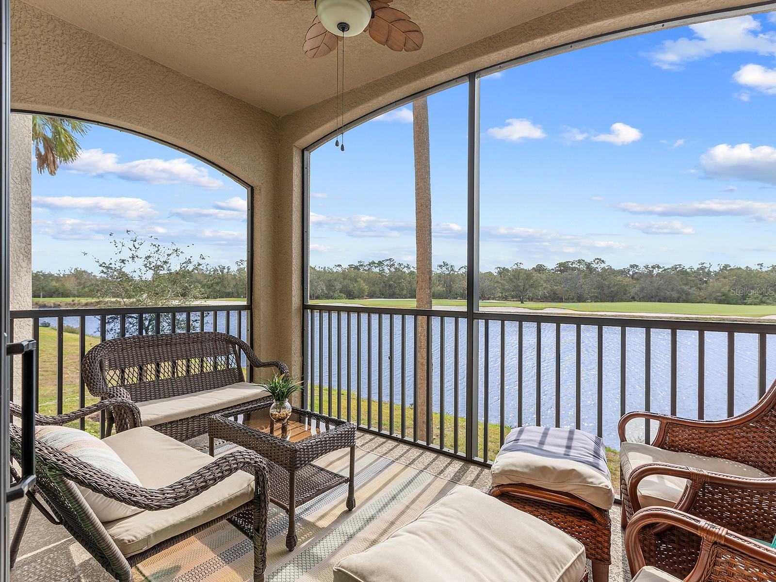 AFFORDABLE CONDO is offered FURNISHED and with full GOLF MEMBERSHIP! Don't miss this incredible opportunity! Overlooking the 11th hole of the Commander golf course at Lakewood National, sits this charming and FURNISHED Birkdale floor plan condo. With 2 bedrooms and 2 full bathrooms, and boasting both beautiful lake and serene golf course views, this unit is perfect for those looking to "right-size", for a seasonal home, or an investment opportunity with 30-day rentals allowed. Included in your HOA dues is membership to Lakewood National, allowing you to take advantage of the resort-style amenities including two 18-hole championship golf courses, the Piper and Commander, both designed by Arnold Palmer. Also included is access to the grand clubhouses, resort-style pool, 8 tennis courts, 4 pickleball courts, fitness center, spa, restaurant, and more. You almost never need to leave the neighborhood! This unit includes a covered carport parking space, and easy access via the stairs or building elevator to the second level which is perfectly positioned to take in the views. The interior is graced by large format tile flooring, crown molding, an open floor plan, and impressive southern exposure views. The great room is centrally located with remote-controlled blind and sliding glass doors to the private, screened in, paver balcony overlooking the lake and golf course. The kitchen is outfitted with abundant solid wood cabinetry that reaches to the ceiling, 2024 rechargeable undercabinet lighting, central island with counter-height seating, granite counters, and stainless-steel appliance suite. The dining room offers large bay-style windows to take in the views, and enough space to even add a small desk for more functional space. Enjoy enhanced style with 2022 kitchen pendant lights and 2022 dining room chandelier. The primary suite has plush carpeting, large walk-in closet, and en-suite bathroom with walk-in shower. The guest bedroom is equally as comfortable with an adjacent full bathroom. Peace of mind is secured with impact windows and doors throughout, easy "lock and leave" living, 2024 rechargeable motion sensor light at the front door, surge protection and large storage room outside of your unit just for you. Included in the Lakewood National condo dues are cable, internet, water, sewer, building maintenance, pest control, elevator, and an exclusive pool located just steps away for convenience. Lakewood National is one of the area’s premier gated communities for elevated, resort-style living. Lakewood Ranch, the top multi-generational community in the country for seven years in a row with plentiful shopping, dining, A-rated schools, parks, and nearby beaches.