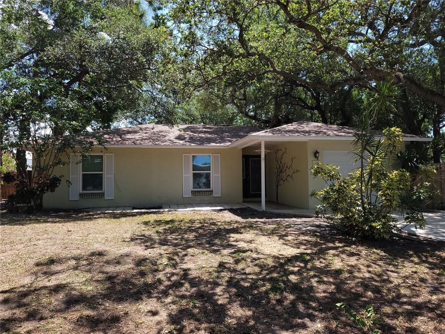 3/2 with attached single garage sitting on a single lot PLUS 22 extra feet on a treezy street in the middle of Sarasota!  New Roof (this week!), New septic (May 2025). Replaced windows are hurricane proof with impact glass.  Hurricane panels for glass sliders are provided as well. Pressure washed and ready for new paint. LVP floors throughout with large closets and lots of storage.  Room dimensions are estimated. This house is ready for a family to love it. Don't pass it by, it is a great value and a great opportunity.
