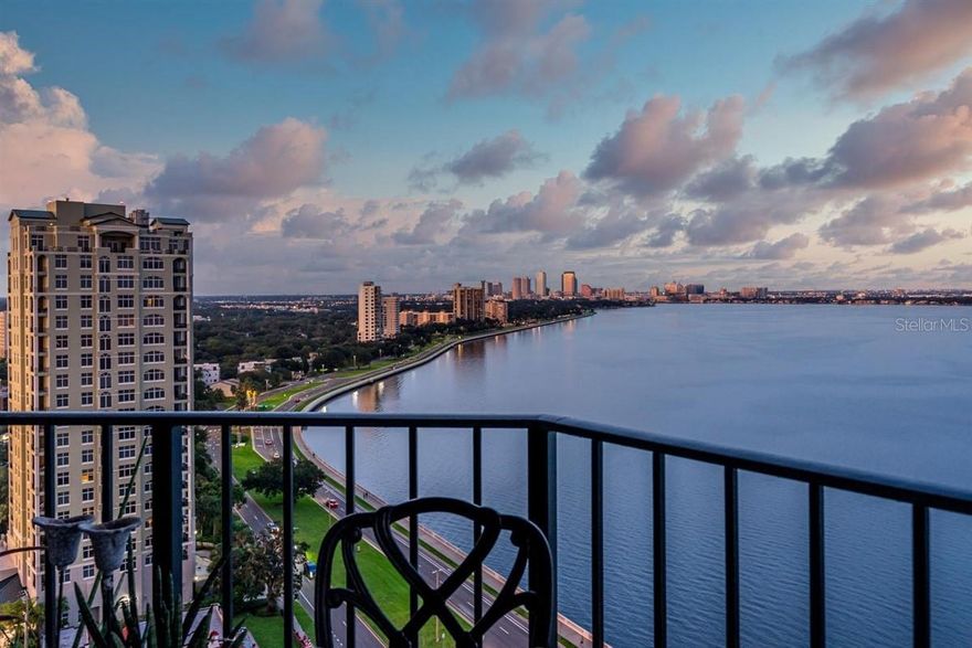 Welcome to the pinnacle of luxury living on the iconic Bayshore Boulevard! Balcony Unit designed by renowned interior designer Tommy Lamb, this extraordinary sky-high residence spans over 4,100 SF on the 22nd floor, offering unobstructed, panoramic views of Tampa Bay, Hillsborough Bay, and Downtown Tampa. This fully customized 4 bedroom, 4.5 bath home seamlessly combines two units into one breathtaking masterpiece where no detail has been overlooked. Step off your private elevator into the beautiful foyer and experience rich wood floors with porcelain tile inlay, setting the tone for the exceptional craftsmanship throughout. The expansive living space features floor-to-ceiling windows, a custom wet bar, and sweeping views—perfect for entertaining. The chef’s kitchen is a showstopper, featuring Italian cabinetry, a 96-bottle wine display, walk-in pantry with prep sink, and premium Wolf and Sub-Zero appliances. A hidden butler’s pantry, two wet bars, and a formal dining room that comfortably seats 12 elevate your hosting game. The luxurious primary suite includes a private balcony, spa-inspired bath, and a massive custom closet with water views. All guest suites offer en-suite baths and stunning vistas. Additional features include smart home automation, custom lighting, electronic roller shades, vanity mirror TV, and bespoke closets throughout. Enjoy the convenience of 3 dedicated parking spaces, a private storage unit, and a climate-controlled storage cage. Monte Carlo Towers offers resort style amenities: a 24,000 SF marble lobby, 24-hour concierge, two guest suites, heated pool, grilling area, social room with commercial kitchen, library, fitness center with saunas, and tennis/pickleball courts. Located in a top-rated school district and just minutes to Downtown, Hyde Park, SOHO, Riverwalk, and Tampa International/St. Pete Clearwater Airports, easy access to major highways, including I-275, I-4, and the Selmon Expressway with the nation’s longest continuous sidewalk right outside your door. Experience elevated living at its best—schedule your private tour today!