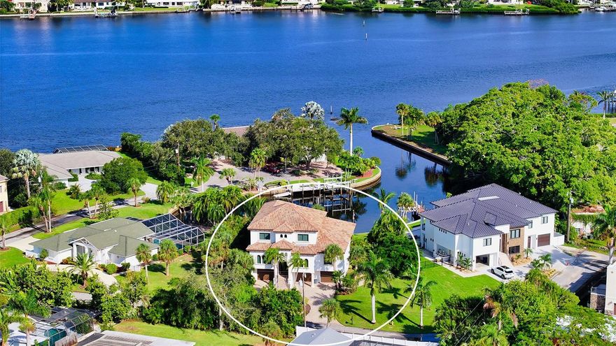 Welcome to paradise! This remarkable waterfront residence offers the epitome of luxurious Florida living with WATER VIEWS in EVERY ROOM. Boasting 3 bedrooms, 3 bathrooms, plus a den, this home is a masterpiece of modern design and functionality with amazing water views from near every room in the home and is perfectly situated on a Dona Bay basin with direct access to the ICW with no bridges!
Situated on a prime waterfront lot with an impressive 90 feet of Intracoastal Waterway (ICW) frontage, with a 10,000-pound boat lift and dock. Home was meticulously constructed in 2012, surpassing current hurricane code requirements ensuring both durability and peace of mind.
Step inside to discover a host of upscale features, including a dual-zone AC/heat system, instant hot water, two electrical panels, and a whole-house generator for added convenience and security. The tile roof, Sonos Sound System, and PGT Thermal Hurricane Impact resistant windows and doors exemplify the home's commitment to quality.
Elegant details such as crown molding, 8-foot doors, plantation shutters, and 16x16 travertine tile are found throughout. The main living area showcases a chef's dream kitchen with 2-islands, granite countertops, top-of-the-line appliances, including a six-burner gas stove, and a massive pantry with a second refrigerator. Maple cabinets with under-mounted lighting add to the kitchen's allure. The dining area seamlessly opens to the lanai through a 90-degree slider, creating a perfect indoor-outdoor flow with a full ODK.
The great room impresses with soaring 20-foot ceilings, while a large office with French doors offers a quiet workspace. The master bedroom features two walk-in closets, a storage closet- but built to allow for an elevator addition, double tray ceiling and an ensuite bathroom with his and her vanities featuring granite countertops, step-ins shower with 2-showerheads, and a garden tub. A huge laundry room features built-in cabinets with undermounted lighting, and granite countertops. A full guest bath boasts a step-in shower with a glass enclosure and stylish vanity and sink.
Level three showcases fossilized bamboo flooring and two spacious bedrooms, 1-with a walk-in closet and the other with an armoire closet. Bedroom 3 and the loft area share a Jack and Jill bathroom with a separate water closet. The loft area provides a wet bar area with a fridge, ice maker, microwave, and sink, all surrounded by solid cabinets and can easily be converted into a fourth bedroom if desired.  
The ground level of this home offers endless possibilities, featuring an oversized 3-plus car garage and two defined areas, currently used for storage. This area can be great for a teenager, or for multi-generational living. Plumbing has been roughed-in for an added bathroom which could double as a cabana bath or ensuite should an area be made into another bedroom. The second storage area can be converted into a playroom, theater room, home gym, or – the possibilities are endless! Both areas have amazing water views with sliders to the pool area.
Step outside to experience the expansive pool area, complete with the option to add an additional ODK. The heated pool is equipped with alarms on the doors for added safety. The wrought iron fencing surrounds the property, providing both security and style. Don't miss out on this exceptional home!