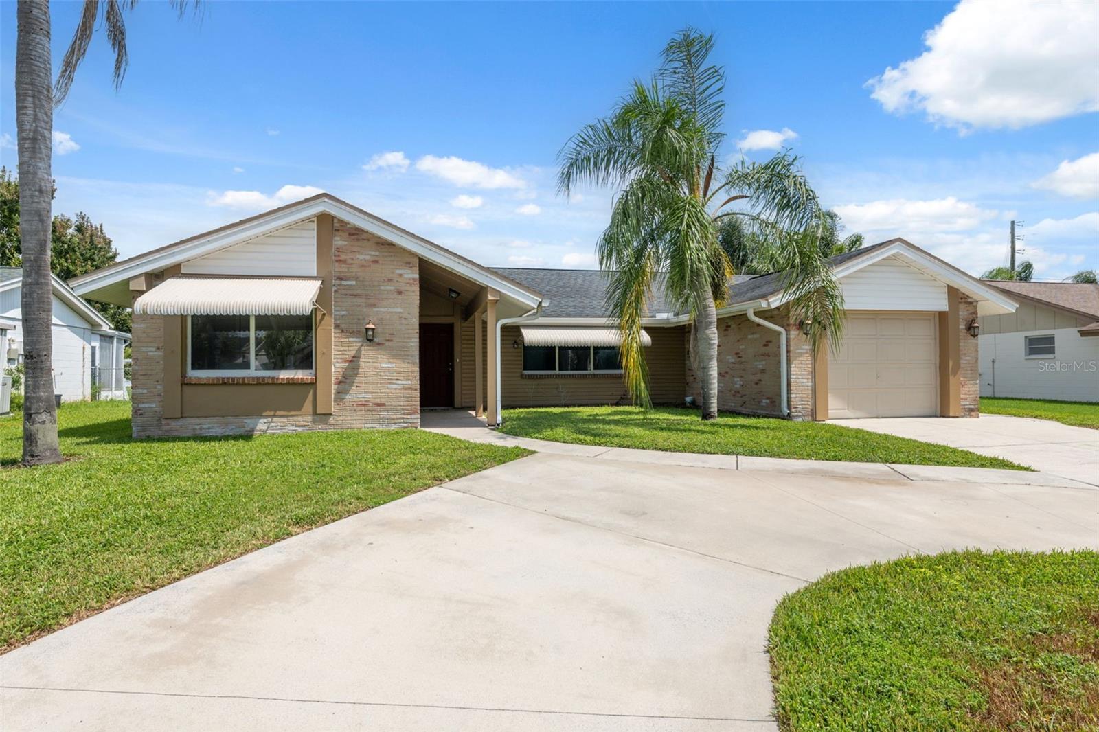 Waterfront Living at Its Finest!
This beautifully remodeled home offers stunning canal views and a versatile layout that includes a private mother-in-law suite with its own eat-in kitchen, bedroom, and en-suite bath featuring travertine floors.
The main home showcases a fully updated kitchen with self-closing wood cabinetry, granite countertops, travertine backsplash and floors, and Whirlpool stainless steel appliances. Both main bathrooms have been tastefully remodeled with granite vanities, new fixtures, and travertine showers or baths. Throughout the home, you’ll find rich wood flooring, crown molding, six-inch baseboards, and raised panel doors for a refined finish.
Major updates—roof, AC, double pane windows, and interior/exterior paint—were completed in 2016, offering peace of mind for years to come.
Outside, enjoy a screened-in lanai with a fountain overlooking the canal, perfect for watching wildlife and sunsets. The circular driveway adds convenience and curb appeal. Just down the street, you’ll find a community pool and clubhouse, with beaches, parks, shopping, schools, and the charming downtown New Port Richey and Tarpon Springs Sponge Docks nearby.
Move-in ready and waiting for you to start your waterfront lifestyle!