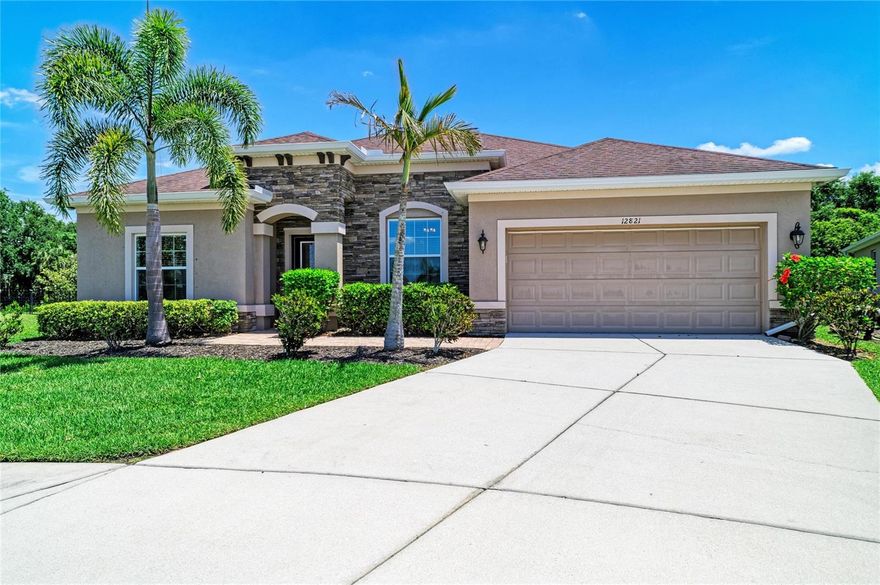 Positioned within the gates of Greyhawk Landing, this Ryland Homes built Inverness floor plan offers a spacious and flexible layout designed for everyday living and long-term comfort. With 5 bedrooms, 3.5 bathrooms, a dedicated den or study, and approximately 2,861 square feet, the home provides the kind of separation and functionality that works well for multi-generational living or anyone needing defined space to spread out. At the center of the home, the kitchen is designed to bring people together, featuring custom cabinetry, a large stone island, and stainless steel appliances including a gas range. It opens naturally to the main living areas, creating an easy flow for both daily routines and gatherings. Tile flooring runs throughout the main living spaces, with wood-look tile extending into the living room and all bedrooms, offering a consistent and low-maintenance interior. The primary suite is privately positioned at the rear of the home, complete with a walk-in closet, dual vanities, soaking tub, and walk-in shower. Sliding glass doors lead directly to the extended stone lanai, creating a seamless transition to outdoor living. The backyard is fully fenced and offers generous space on both sides of the home, providing flexibility for pets and play. Major systems have been addressed with the HVAC replaced in 2021, adding peace of mind for the next owner. Additional features include a 3-car tandem garage with electric vehicle charging capability, a dedicated laundry room with utility sink, and ample storage throughout. Greyhawk Landing is a guard-gated community known for its mature landscaping and established feel, offering two community pools, a fitness center, tennis and basketball courts, fishing pier, and miles of walking trails. Conveniently located with access to top-rated schools, shopping, dining, and the Gulf Coast beaches, this home presents a solid opportunity within one of the area’s most established neighborhoods.