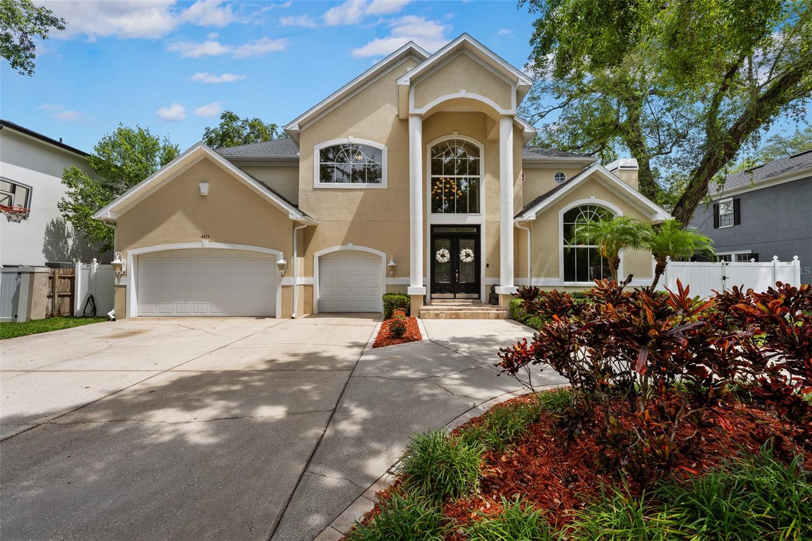 This distinguished 5-bedroom, 4.5-bath residence in South Tampa's exclusive Sunset Park offers an exceptional fusion of classic elegance and contemporary functionality. Significant updates include a 2018 roof and 2025 HVAC air ducts, ensuring modern comfort and peace of mind. Upon entry, a two-story, pillar-framed entrance reveals a grand foyer featuring 22-foot ceilings, a 30-light motorized chandelier, and arched window. The gourmet kitchen, fully customized in 2016, is equipped with a 4-foot Wolf gas range, Thermador refrigerator, granite island, and a window-lined breakfast nook with abundant natural light and pool views. A wet bar, complete with a wine refrigerator and R/O system, complements the sophisticated living room, which features French doors opening to the lanai. The formal dining room is appointed with crown molding and built-in speakers, while the family room offers a gas fireplace, cathedral ceilings, and a sizable arched window. Outdoor amenities include a covered lanai with recessed lighting and a ceiling fan, leading to the saltwater pool with a zero-entry tanning ledge and a raised hot tub. The expansive primary suite features a double-door entry, slanted tray ceilings, transom windows, and a large walk-in closet with adjustable built-ins. Its en-suite bathroom includes a jetted soaking tub, a spacious glass walk-in shower, and dual granite vanities with ample storage. Two guest bedrooms share a Jack and Jill bath, and a fourth guest bedroom includes a built-in closet and large window. The media room, accessible via a double-door entrance, features a granite wet bar, providing an ideal space for entertainment. An upstairs laundry room with a utility sink enhances convenience. Further notable features include hardwood floors, crown molding, white vinyl fencing with double gates, a three-zoned HVAC system, and two gas water heaters. Located on a quiet, upscale street within the desirable Plant High School district, this home offers convenient access to parks, shopping, dining, community amenities, and major transportation routes. We invite you to schedule a private showing to experience this exceptional property.