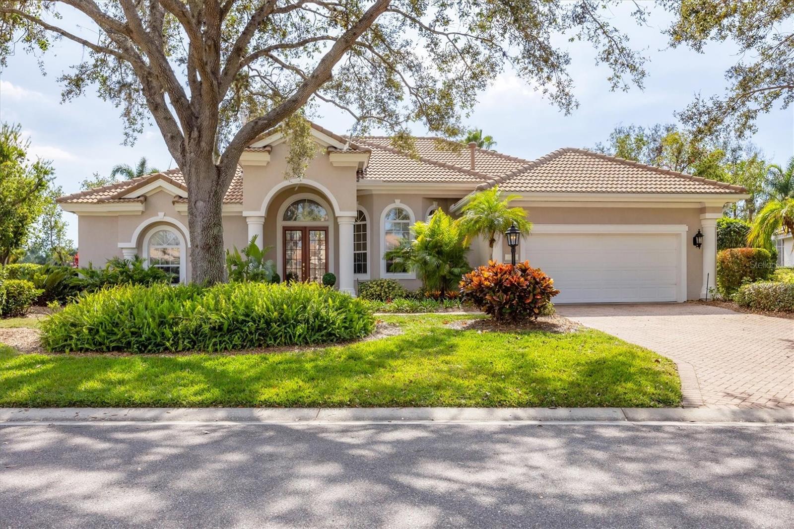 County Club Living in Culturally Rich Sarasota
Discover a refined way of living at University Park Country Club, where gated luxury meets a delightful blend of community, recreation, convenience, and culture. Thrive on year-round access to 27 holes of four-star golf, 4 pickleball courts, 11 Har-Tru lighted courts with competitive league play, fitness center, walking paths through mature landscaping, and a vibrant social calendar welcoming you into the community where new friendships begin. A casual favorite of the club is the outdoor patio bar and grill with serene views of the lake and golf course.
This is the community setting to our luxury waterfront sun filled residence sited on an oversized lot with mature landscaping and lake view. Built in 2003 by Pat Neal, the home enjoys oversized windows and sliding glass doors opening to the screened pool patio area, a 2020 roof, 10 ‘ ceilings, all lending to a secure sunny airy Florida feel. The intelligent split floorplan surprises you with a large bonus room in the rear of the house with sliding glass doors to the pool and a big window facing the trees. There is a wonderful flow between the living room and the kitchen family room keeping it both separate and open. It gives space for guests and places to simply be. The kitchen serves as the heart of the home with a center island, breakfast bar, dry bar connecting to the dining room, and a delightful breakfast area with a glistening view of the lake. The guest wing offers two bedrooms, the bonus room, and two full hallway baths. The primary suite has two walk-in closets, separate vanities, tub, walk- in shower, and water closet. The large bedroom has a sitting area and a door accessing the pool patio. The pool patio has both a covered area for shade and open areas for sunning, a spa, heated pool, and a swim in place pool mechanism for exercise.
Location is mere minutes to all the shopping, restaurants, Benderson Park, Mote Marine and 7 miles to Downtown Sarasota the heart of the Cultural Coast of Florida with café lined streets, live theatre, music and art festivals, ballet, opera, museums, colleges, marinas and waterfront parks. Come live the dream!