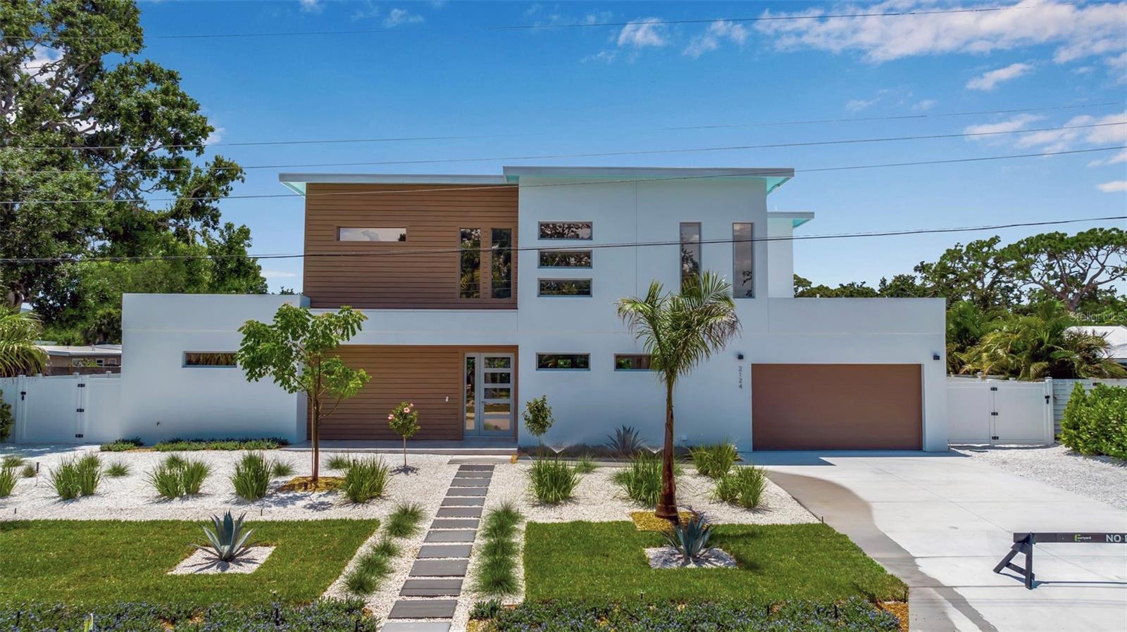 Welcome to 2124 Clematis Place, a newly completed, design-forward residence by Courtyard Modern in the heart of one of Sarasota's most desirable neighborhoods. Influenced by the Sarasota School of Architecture, this 6-bedroom, 6-bathroom home offers clean lines, bold scale, and seamless indoor-outdoor connection across 3,574 square feet of air-conditioned space. The main living area is defined by volume and natural light, with polished concrete tile floors and a minimalist material palette. Custom cabinetry, quartz countertops, and a suite of premium appliances set the tone in the kitchen, while the flexible floor plan allows space for work, guests, or a growing family. Step outside to a private courtyard oasis, complete with a saltwater pool and spa, fenced yard, and low-maintenance zeroscaping to allow for time to enjoy the amenities. Ideally located just minutes from downtown Sarasota, Southside Village, and Sarasota Memorial Hospital, with quick access to Siesta Key, Lido Beach, and St. Armands Circle. Arlington Park itself is just around the corner, offering lap swimming, tennis, a dog park, and year-round activity. In a neighborhood surrounded by custom homes and strong long-term fundamentals, this is a rare chance to own a modern architectural home that doesn't just look the part, it lives beautifully too. Schedule a showing today!