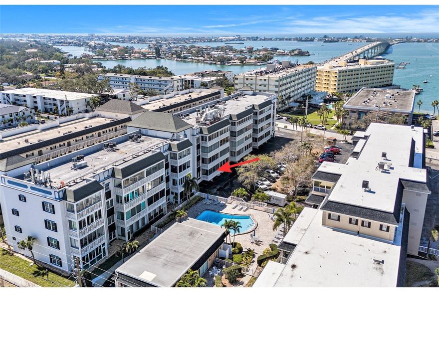 Welcome to this tastefully renovated condominium, located on the second level above the parking area in a non-flood zone. There was no water intrusion from Helene or Milton. This condo has a great flow and positive energy throughout.  Enjoy a spacious open layout with a family room that seamlessly connects to the dining area and a bright Florida room – ideal for relaxing or entertaining guests.  The entire unit features beautiful tile flooring, providing a sleek and low-maintenance aesthetic. The kitchen cabinets were recently updated providing a modern style and great storage. The condo features two spacious bedrooms, each with its own en-suite bathroom with walk-in closets for added convenience and privacy. Perfect for active adults seeking a vibrant, social lifestyle in a secure and peaceful setting.  Building No. 3, has recently undergone exterior renovations, and a Milestone Inspection (June 2024) confirmed the building’s safety and integrity, providing peace of mind for new owners.  The location is great! Located less than 2 miles from pristine beach access and steps away from popular dining spots like Westshore Pizza and Bonefish, this condo offers the best of coastal living. The community offers a range of fantastic amenities, including a beautiful pool for relaxation, a clubhouse for social events and activities, a grill area for outdoor meals, and a project room. This condo also includes one assigned covered parking space with more spaces available for guest parking, making it easy for visitors to enjoy your new home. Don’t miss your opportunity to own a great condo in a fantastic location. The roof was replaced in 2021, the pool was resurfaced in 2024, and a new pool pump was recently installed. Call us today for a private tour.