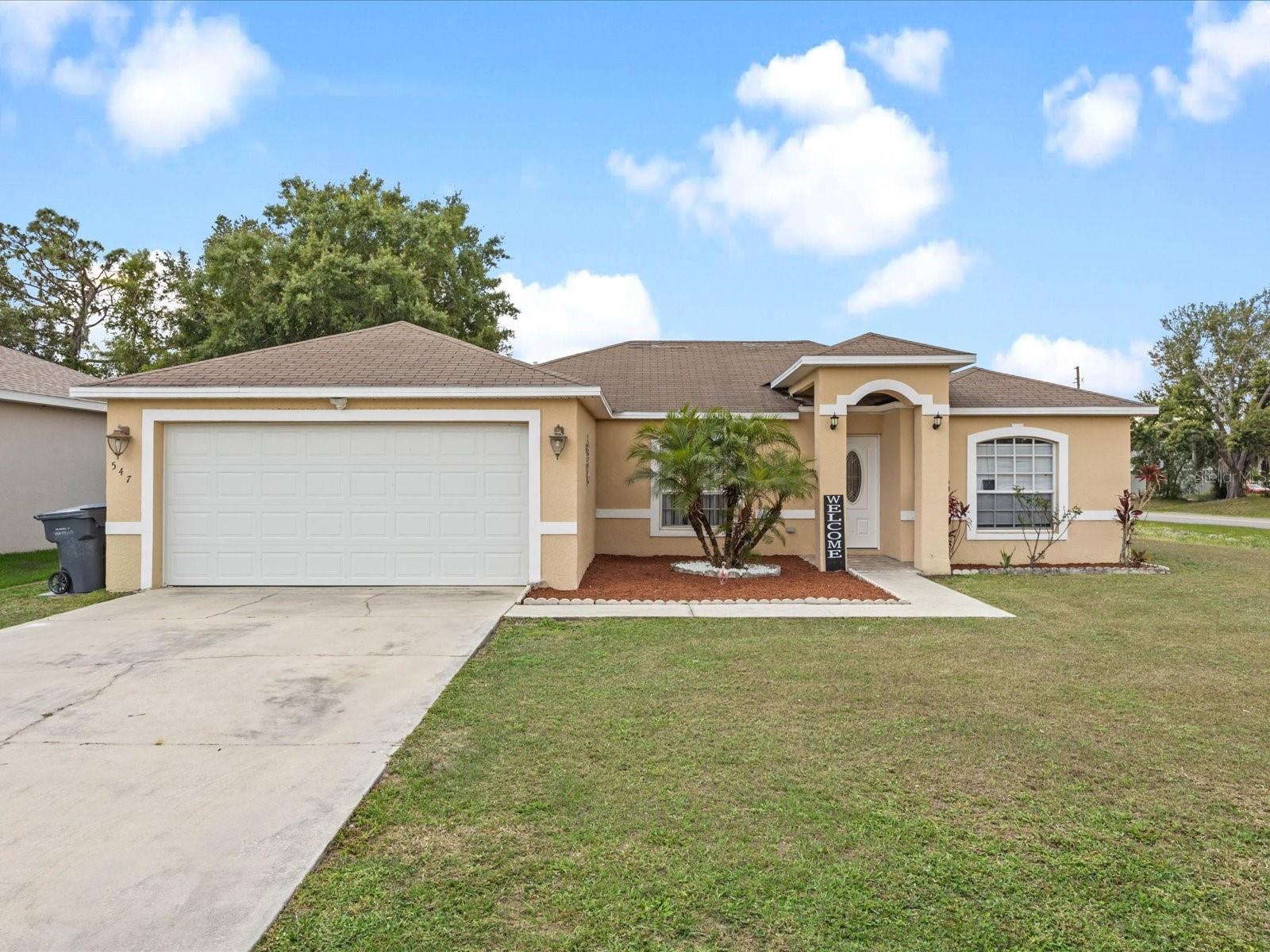 REDUCED! Sellers MOTIVATED! Welcome to this delightful single-story home in Poinciana, Florida, offering a cozy and functional living space. As you step inside, you are greeted by a warm and inviting family room, providing a comfortable gathering area for family and friends. The sliding doors offer a seamless transition to the expansive fenced yard, creating a blend of indoor and outdoor living.To the left of the entryway, you will find the well-designed eat-in kitchen, perfect for casual dining and culinary adventures. The kitchen boasts ample counter space, a breakfast bar and a convenient layout that allows for efficient meal preparation. The eat in kitchen is ideal for enjoying meals with loved ones and features large window that fill the space with natural light. Located to the left of the family room, the master ensuite offers a private and serene retreat. This spacious bedroom is designed with relaxation in mind and includes an en-suite bathroom for added convenience. Continuing through the home on the right of the entryway, you will discover two additional generously sized bedrooms that provide comfort and flexibility. These bedrooms can be utilized as guest rooms, home offices, or spaces for hobbies and activities. A full bathroom, conveniently located in between, serves both of these bedrooms and completes the functional layout of the home. Outside, the fenced yard provides a private area for outdoor activities and gatherings. Enjoy the Florida sunshine in your own backyard oasis, perfect for gardening, barbecues, or simply unwinding after a busy day. For those with vehicles, a two-car garage ensures ample parking space and provides added storage options for your belongings. Additionally, the driveway allows for extra parking for guests. This home is conveniently situated near a variety of local amenities, including shopping centers, dining establishments, and recreational facilities. The community also offers access the community pool and gym for a fee. Don't miss out on this fantastic opportunity to own a beautiful single-family home in Poinciana, Florida. Call now to schedule a viewing and see firsthand the charm and comfort this property has to offer.