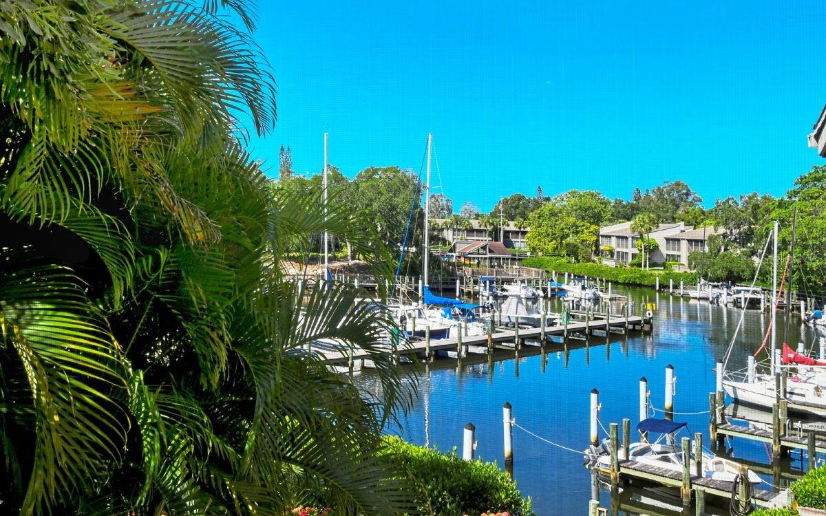 ***AVAILABLE MAY 2025***This is having your cake and eating too. Wait till you see the beauty and convenience of this condo. Located on the second floor, your new rental has cathedral ceilings and is drenched in sunlight with a full view of the yacht basin. Completely renovated in 2016 with fantastic upgrades in both bathrooms and the kitchen. Location in the complex is key, across from the tennis courts and wellness center and just steps to kayaking. Phenomenal views both day and night. Pelican Cove is a 75-acre, gated, vibrant, waterfront community nestled among manicured tropical foliage truly offering something for everyone. Abundant amenities include the 86-slip boat harbor with excellent rates & a launch dock for kayaks and canoes, 6 heated swimming pools, hot-tub, 3 clubhouses, 4 lighted tennis courts, shuffleboard, basketball, dog walk area, walking trails and boardwalks as well as fishing gazebos, water exercise classes, exercise facility, 2 art studios and a pottery classroom. Take classes at Pelican Cove University or join one of the more than 37 clubs for photography, fiber art, bike riding, culinary arts and card clubs. Woodworking, sculpting, and evening jazz & classical music concerts round out the active lifestyle. Come and see what you a great place Pelican Cove is to rent.