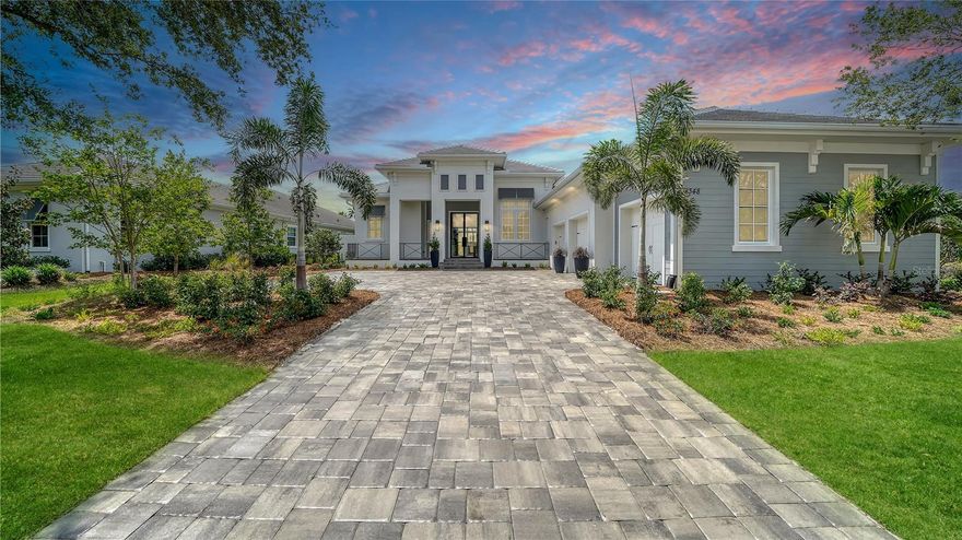 Under contract-accepting backup offers. Set in the prestigious Phase 1 section of The Lake Club, this practically new home, just four months old, showcases impeccable craftsmanship and luxurious design. Built for both beauty and resilience, it features hurricane impact windows and doors, soaring ceilings with custom details, and exquisite finishes throughout. The professional kitchen boasts Wolf and SubZero appliances, stunning cabinetry, convenient center island, and a custom walk-in pantry. The main house offers three bedrooms, while a separate guest casita provides an oversized bedroom, kitchenette, and full bath. An en suite bonus room with zero-corner sliders to the lanai can easily convert to a fifth bedroom. Complete with private access to the lanai, the serene primary suite includes a spa-like bath with a soaking tub, walk-in shower, dual vanities, and a private water closet. Additional highlights include a dedicated office with double glass doors, a powder bath, a laundry room with expansive cabinetry and utility sink, and custom closets throughout. Designed for effortless entertaining, the spacious covered lanai features a top-tier outdoor kitchen, a saltwater pool and spa, and ample space to relax. Smart home technology controls security, climate, lighting, and more, while the pristine garage is oversized and outfitted with epoxy flooring, storage cabinetry, an extra refrigerator, and a split AC unit. Residents of The Lake Club enjoy world-class amenities, including a guard-gated entrance, a vibrant clubhouse, a restaurant and bar, two resort pools, fitness facilities, sports courts, fishing, and scenic trails. Located in Lakewood Ranch, the nation's top-selling multi-generational community, this exceptional residence is just minutes from premier shopping, dining, top-rated schools, and the Gulf Coast's pristine beaches.