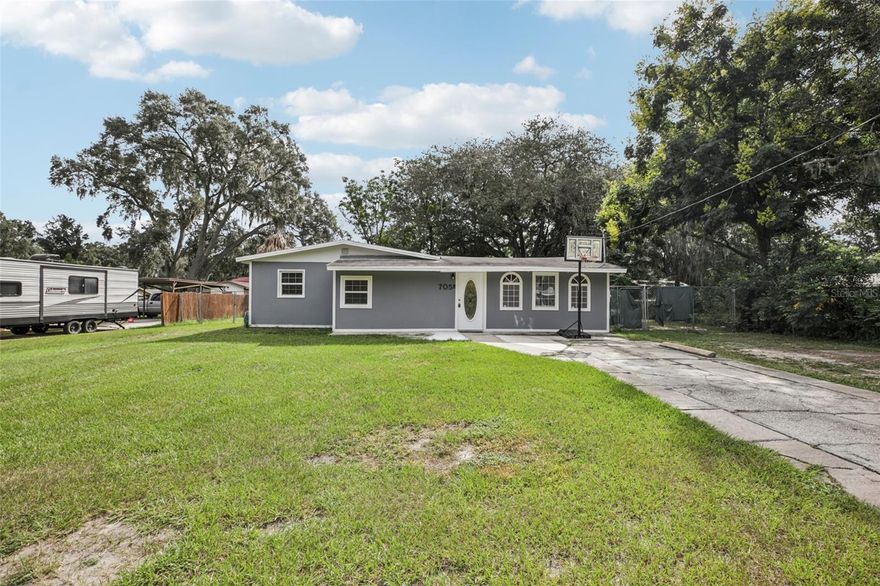 This home is back on the market! This charming 3-bedroom, 2-bathroom ranch-style home offering 1,576 square feet of comfortable living in Fruitland Park. The seller is replacing the roof so get you offer in quick so you may have an input on the color. The home is also having new insulation installed to make it more energy efficient and the wiring is being updated to current code. The home has been freshly painted inside and out, this home features updated lighting and ceiling fans throughout, providing a move-in ready feel. The spacious layout includes a functional kitchen, and inviting living areas. Step outside to enjoy a fully fenced backyard while you sit under your covered lanai, perfect for pets, gatherings, or gardening. A 12' x 24' workshop with electrical service adds versatile space for hobbies, storage, or projects. Best of all, this property has no HOA, giving you the freedom to enjoy your home without added restrictions. Conveniently located close to The Villages, shopping, dining, and everyday conveniences, this home blends comfort with accessibility. Schedule your private showing today!