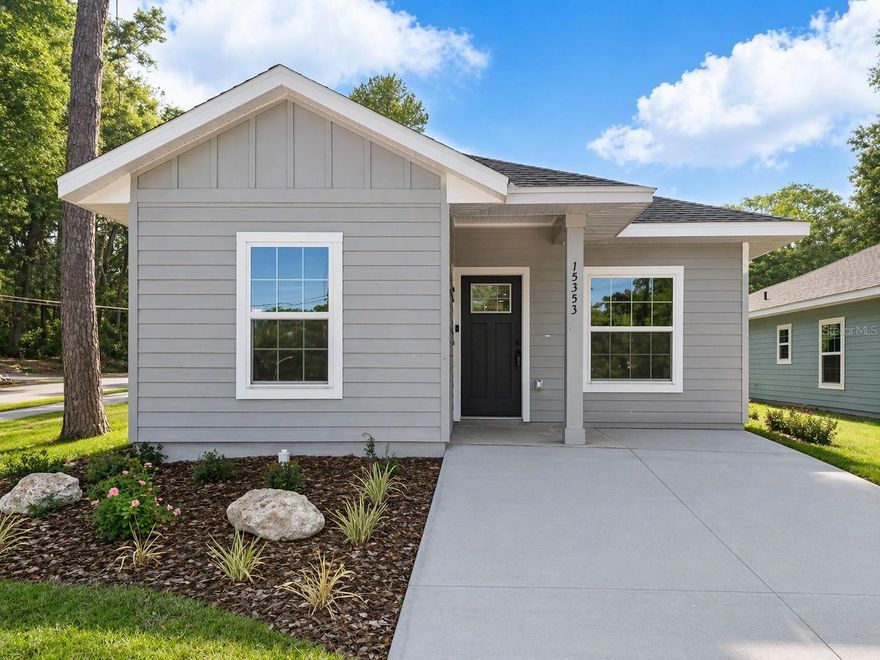 3-bedroom, 2-bath new construction home located in Alachua, FL. This home offers approximately 1,243 heated square feet and is situated on a corner lot with convenient access to I-75 and Gainesville.

The interior features an open living, dining, and kitchen area with quartz countertops and wood cabinetry throughout. Luxury vinyl plank flooring is installed in all main living areas and bedrooms.

The layout includes two bedrooms and one full bathroom toward the front of the home, with the primary bedroom located toward the rear. The primary bathroom features a walk-in shower.

Additional features include a Ring doorbell and modern finishes throughout.