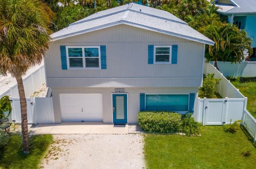 Gorgeous Anna Maria Beach House with rare ROR zoning! This 4-bedroom, 3-bath residence is ideally positioned on Anna Maria Island's historic and most coveted Pine Ave! Nestled just a short 1.5-block stroll from the pristine 7-mile stretch of Gulf of Mexico sandy beaches, this home underwent a complete renovation in May 2022. The upgrades include both kitchens and all bathrooms, boasting granite countertops, kitchen cabinets, modern furniture, rugs, stainless steel refrigerator, and microwave.  Use this a private residence, short term rental or even a business!

Throughout the 2,580 sq. ft. space, you'll find beautiful tile floors and crown molding. The open-concept enhances the overall flow. The house essentially provides two distinct living spaces, separated by a door and separate entrance. The front "in-law suite" features one bedroom and one bath.  The home area boasts updated kitchen and baths, newer appliances and a new stove.  The master bedroom features a private porch overlooking the pool—a tranquil spot to savor your morning coffee.  Downstairs is a one car garage and storage are that is the full footprint of the house! There are 2 brand new water heaters (2023) and 2 washer/dryers (1 upstairs and 1 downstairs). The front of the roof was redone in 2016 and the back in 2022.  This home transfers furnished with minor exceptions. 

If you decide to use this home as a short term rental you are NOT restricted on occupancy due to the commercial zoning.  The zoning also makes this the perfect place to put your business on the coveted Pine Ave!  Conveniently located, The Beach House is just 34 miles from Tampa International Airport and Tropicana Field, the home of the Tampa Bay Rays.