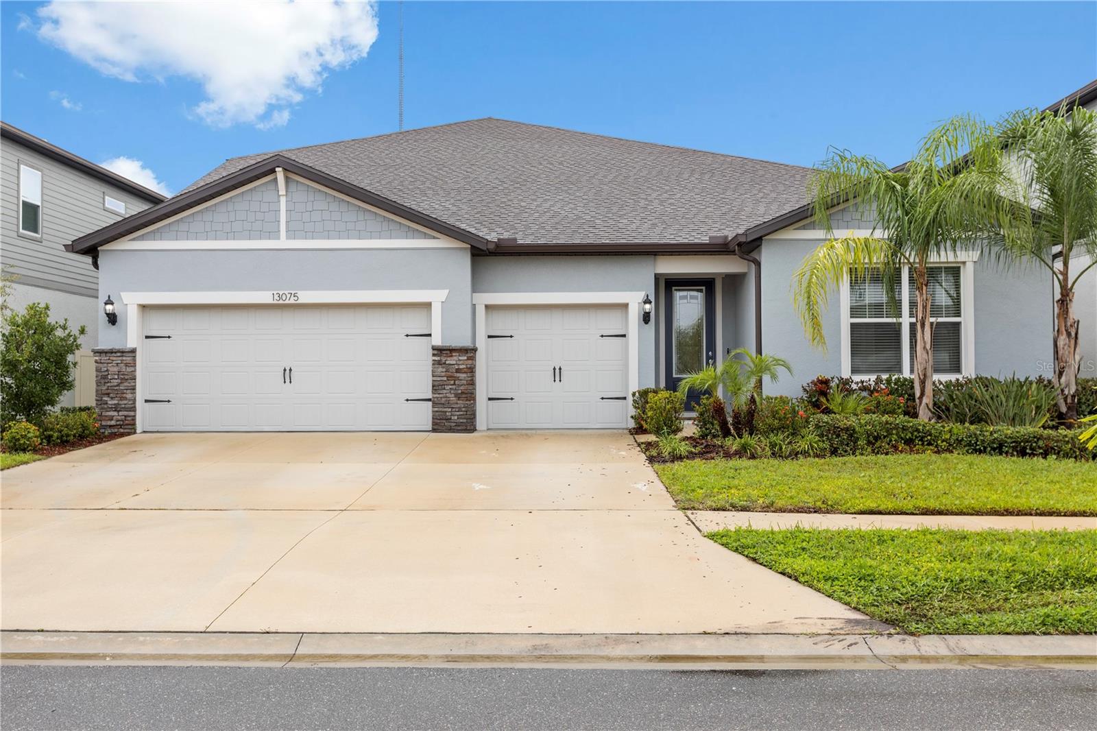 Welcome to 13075 Willow Grove Drive, a stunning 2023-built Pulte Easley floor plan in Riverview’s prestigious Cedarbrook community, offering 5 bedrooms, 4 bathrooms, a dedicated flex/office with French doors, loft, enclosed media room, and over 4,200 sq. ft. of exquisitely upgraded living space. Thoughtfully designed for both elegance and everyday living, this residence is flooded with natural light and features a flowing open-concept layout anchored by a chef’s kitchen that truly steals the show—complete with a striking waterfall island, gleaming 3cm Lagoon quartz countertops, white cabinetry, custom backsplash, and built-in stainless appliances including a Wi-Fi and Bluetooth–enabled oven and microwave combo that allows remote control from your phone for modern convenience and safety, along with an oversized walk-in pantry.
The kitchen blends seamlessly into expansive dining and family areas highlighted by an upgraded custom media wall and a chic wet bar with LED backlighting and custom shelving, creating a refined setting for entertaining. The downstairs owner’s retreat is a spa-inspired haven with dual quartz vanities, a luxurious extended walk-in shower with bench seat, and an oversized walk-in closet designed for organization and style. Additional downstairs bedrooms include a private guest suite with its own en-suite bath and a versatile front bedroom ideal as a playroom, second office, or guest quarters.
Upstairs, two more spacious bedrooms pair with a loft and an enclosed media room, offering endless flexibility for family living, study, or recreation. Every detail reflects uncompromising quality, from designer Lumber White wood-look tile flooring and plush upgraded carpet to quartz countertops in every bathroom, recessed lighting, and an integrated entertainment system with ambient lighting. Added peace of mind comes with the fully integrated security system, providing live exterior video monitoring from the safety and comfort of your home.
The rare independent climate-controlled 3-car garage provides the perfect space for a gym, workshop, or conditioned storage. Sliding glass pocket doors lead to a covered lanai and fenced backyard, the ideal place to restore and relax or plan a future pool. Beyond the home, Cedarbrook offers resort-style amenities including a sparkling pool, playground, sports courts, and scenic walking trails—all with an exceptionally low HOA of just $100/year. With hurricane protection, impact-resistant doors, soaring ceilings, no flood zone designation, and meticulous maintenance, this residence delivers both peace of mind and everyday comfort.
Ideally located near shopping, dining, top-rated schools, Downtown Tampa, and the Gulf Coast beaches, this rare opportunity offers a lifestyle of chic sophistication, security, and modern luxury—all under $700K.