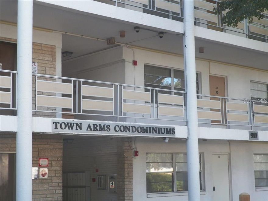 This top floor 2 BR/1 BA condo in the Town Arms Condominiums has a large living room, bonus room off the kitchen. The kitchen has a gas cooktop Kitchen and bathroom with tile floor and Laminate flooring in living room, dining room and bedrooms. The building has an ELEVATOR, security cameras and a community laundry room. This complex is close to everything: shopping, banks, dining, beach is 10 minutes away, parks, bike trails and the LARGO MEDICAL CENTER. Monthly fees include water, sewer, trash, gas (for kitchen cooktop,
heating and cooling and community water heater). This property can also be rented as there is no minimum ownership period requirement. Enclosed Florida room can be used as an office, media room or playroom. The laundry facility is located on the second level next to the elevator. This is not an age restricted community. Sorry pets are not allowed.