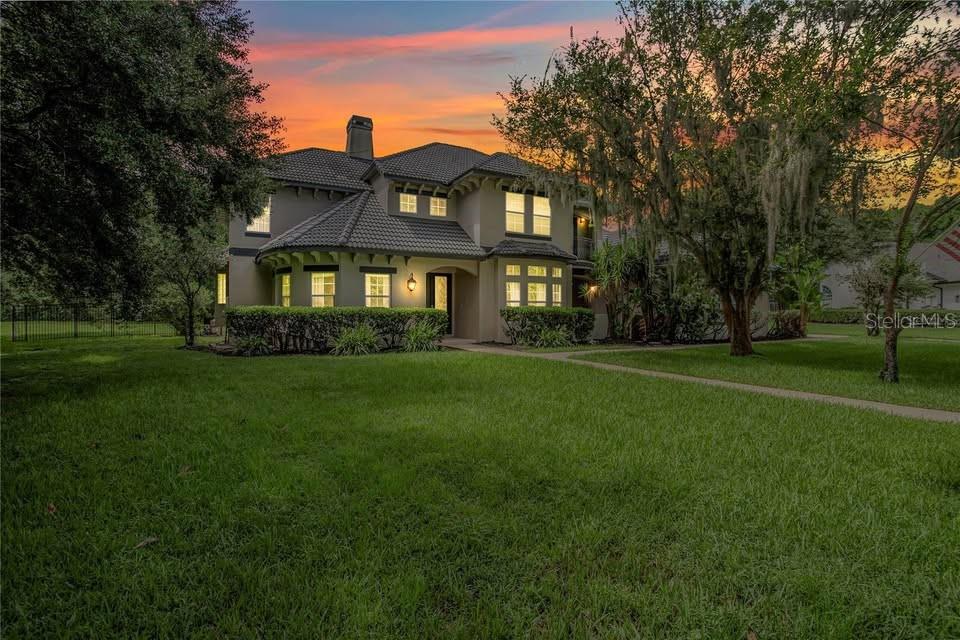 This 6 bedroom, 4.5 bath custom-built home sits on a 1.15-acre lot, and is a beautifully appointed inside and out. The entrance to the home is grand! Its long, circular driveway is the perfect preview that welcomes you to the estate. As you enter, you will be impressed with the high coffered ceilings overhead, and the beautiful hardwood floors below. The abundant natural light will greet you from the family room at to the rear, and creates a welcoming environment for your family and friends. To the left of the entrance is the formal living room that features a beautiful bay window. To the right of the entrance is the oversized dining room with French doors that lead you to the exterior courtyard where you can enjoy your morning coffee or a quiet dinner under the stars. Directly ahead is the family room with double French doors and overhead windows that illuminate the beauty of this home. The kitchen features custom cabinetry throughout and includes a large, walk-n pantry and custom butler’s pantry and wet bar. To the right of the kitchen is oversized laundry room, and an office that also features a French door that opens to the outdoor space. The first-floor master suite will be the perfect place for your at home retreat. It includes a sitting area where you can relax and read your favorite books or wind down at the end of the day. The ensuite bathroom is ideal for a spa day at home. It includes a large, double shower, bathtub, vanities on both sides, clawfoot tub, water closet with a bidet. The oversized, custom-built walk-in closet is to the rear and offers enough space for your wardrobe and more! Also on the first floor, is a second bedroom that is perfect for an in-home office space or guest suite. As you proceed upstairs, you will be impressed by the open walkway with views of the first-floor spaces below. The second level of the home features a media room, and is a split plan with two bedrooms and two bathrooms on either side of the upstairs space. Every bedroom in this home has walk-in closets with ample wardrobe space and storage. To the rear of the home is large outdoor space that features an outdoor kitchen and a large, heated pool and spa. There are no rear neighbors nearby so you can relax in your own private and serene setting. Being a resident of the neighborhood comes with exclusive access to the lake, tennis courts and community park. This meticulously maintained home is a must see! Schedule your private showing today.