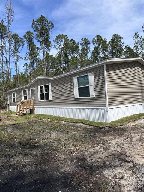 Photo of 1391 Beech Boulevard, Bunnell, FL 32110 (MLS # TB8367211)