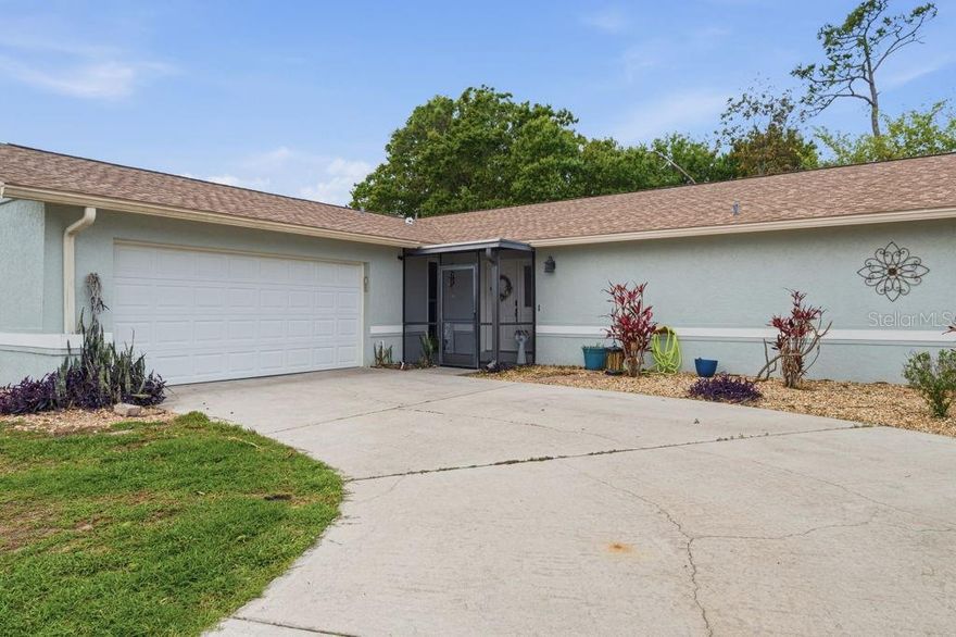 Well maintained 3-bedroom, 2 bathroom ranch style house in a quiet cul-de-sac in Deep Creek, so there is no through traffic.  Enter through the screened in entryway to a beautifully redone home.  You will enter into a carpeted great room that looks out to a greenbelt, (meaning no backyard neighbors)  This allows for you to install a hot tub, that the lanai is wired for.  You don't have to worry about anything being built behind your home.  Step through the hanging barn doors into the gallery kitchen, which features granite counter tops, stainless-steel appliances and wood cabinets that leads to a  breakfast nook that overlooks a beautiful backyard.  The split level house offers 2 nice sized bedroooms.  The roof (installed in 2022), A/C (2018), Hot Water heater (2023), house plumbing was redone in 2018, new gutters, hurricaine windows and other updates makes this property worry free for the new owners. The swingset in the backyard is included in the sale.   Bring your decorating ideas and make this house your home.