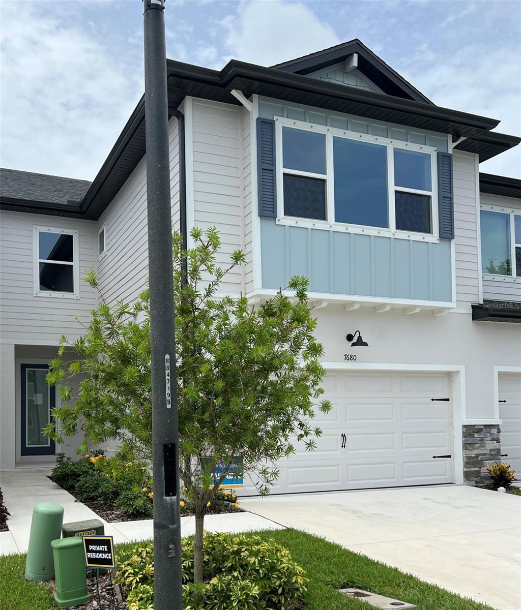 Incredible opportunity to live on the pond with fountain view in the award-winning B Model! This home boasts 3 bedrooms, 2.5 bathrooms, and 2 car garage with designer selected features such as light and bright soft close cabinetry, dark cabinet hardware, quartz countertops with distinct veining, tile backsplash and stainless-steel appliances. Entertainment friendly with open great room plan, high ceilings, and low maintenance luxury vinyl flooring throughout the first floor. Screened in lanai offers flexibility to open up on the cool days of fall and winter! Decorative iron spindles and stained oak treads with painted risers make for a showstopper staircase leading up to the private sleeping quarters. Elegant and private primary suite tucks in at the back of the home viewing the fountain and water. Marble look tiles, quartz, floor to ceiling tile in the glass enclosed shower lend to spa like ensuite feel. Guest rooms are more spacious than you might expect with thoughtfully designed windows and ball catch closet doors. 9'4 ceilings in the second story lend to the spacious feel. Just a short 2.5 mile drive to three very popular beaches, close to dining, fitness, shopping, boating, night life and located in flood zone X! Make your appointment today, you won't be disappointed!!