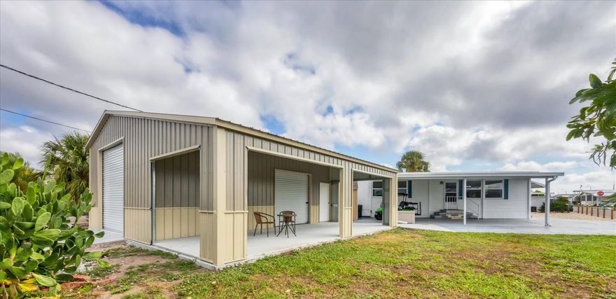 Behind these doors lies the ENVY OF EVERY MAN ON THE BLOCK! A gorgeous Coastal Farmhouse renovation, 2 Bedroom, 2 Bathroom Double Wide Mobile Home, AND a brand NEW 20'x30'x11' detached Garage with attached 12'x30' Carport! Situated on a fantastic double corner lot (almost 6000 sq ft) in the highly desired, active 55+ Trailer Estates community, this property is just one block from the Trailer Estates Marina. Custom Kitchen cabinets, new stainless steel appliances, quartz countertops and ceramic tile backsplash. Custom Bathroom cabinets, solid surface countertops with integrated bowls. New washer and dryer. Luxury vinyl floors throughout, no transitions. All windows and doors replaced. Upgraded insulation. Roof 2019; new AC motor 2024. WDO treated 2025. Paver patio for grilling and gathering, and a separate 8x10 Shed complete this piece of Paradise. The new Garage building has just been completed and electric and water is available and ready for installation, if needed. Bring your classic car, bring your boat, bring your project...the only thing missing is your Big Boy Toys! You own the land. No lot rent, Park Fees are included into annual real estate taxes. Boaters have direct access to Sarasota Bay from the Marina. Trailer Estates community offers so many options for a great day! Enjoy the large, heated community pool, hot tub, gym and wood shop. The community buzzes with pickleball, shuffleboard, kayaking, horseshoes, bocce, dancing and more. A US Post Office on site. 10 minutes to the SRQ Airport. Convenient to shopping, restaurants, the Arts and everything in Bradenton/Sarasota. Sold unfurnished. Bring offers!