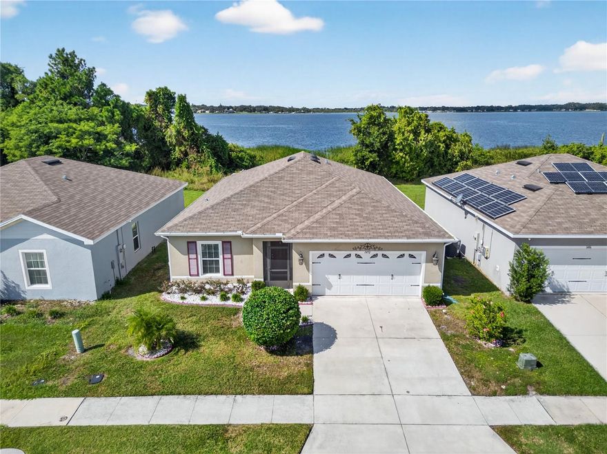 One or more photo(s) has been virtually staged. Nestled within the serene waterfront community of The Lakes at Lucerne, 1492 Haines Drive invites you to experience lakeview living at its finest. This nicely upgraded, well-cared-for home offers four spacious bedrooms, two full baths, and over 1,700 square feet of relaxed living. Inside, a thoughtfully designed floor plan blends open-concept living with tranquil water views—perfect for everyday comfort and effortless entertaining. From the moment you enter, the foyer sets the tone with detailed wall trim and a welcoming sense of style. Tile flooring flows through the main living areas, complemented by high ceilings, updated fixtures, and abundant soft natural light. The great room and dining room combination provides a wide-open feel, allowing furniture placement tailored to your lifestyle. At the heart of the home, the kitchen features quality cabinetry, a tile backsplash, soft-close drawers, an island with breakfast bar, and a pantry—highlighted by sleek stainless steel appliances.
The triple-split bedroom layout ensures privacy for everyone, with all bedrooms offering generous dimensions, ceiling fans, and ample storage. Quietly positioned at the rear, the primary suite showcases peaceful lake and wooded views, a walk-in closet, and an en-suite bath with dual sinks and a tiled walk-in shower. Step outside to the large screened lanai where you can relax and grill while enjoying visiting birds, refreshing lake breezes, picturesque views and unbelievable sunsets. The backyard is fully enclosed with vinyl fencing, creating a private and serene outdoor space for pets or gatherings. Additional highlights include gutters around the entire exterior, an inside laundry room, a 2 car garage, water softener and reverse osmosis system.
The Lakes at Lucerne offers a peaceful, well-maintained environment with convenient access to Hwy 27, Interstate 4, and the Polk Parkway—placing you near all the essentials for comfortable Florida living. Nestled in the heart of Central Florida, Winter Haven perfectly blends small-town charm with modern convenience. Whether you’re searching for a retirement home, a winter retreat, or a year-round residence, you’ll love everything this community has to offer. With 50 lakes—including the world-famous Winter Haven Chain of Lakes—you can fish, boat, or simply relax and take in the scenic views. Golf enthusiasts will appreciate eight local courses (three public and five private), plus more than 35 additional options within a 20-mile radius. Beyond recreation, Winter Haven features a vibrant local scene with a weekly farmers market, locally owned restaurants, boutique shops, and family-friendly attractions like LEGOLAND Resort. Everyday conveniences such as Publix, Walmart, Aldi, TJ Maxx, Kohl’s, pharmacies, and medical facilities are all just minutes away. Centrally located between Tampa and Orlando, residents also enjoy easy access to major attractions including Disney World, SeaWorld, the Florida Aquarium, and professional sports venues—all within a short drive. Experience the perfect blend of water views, recreation, and community—schedule your private showing today!