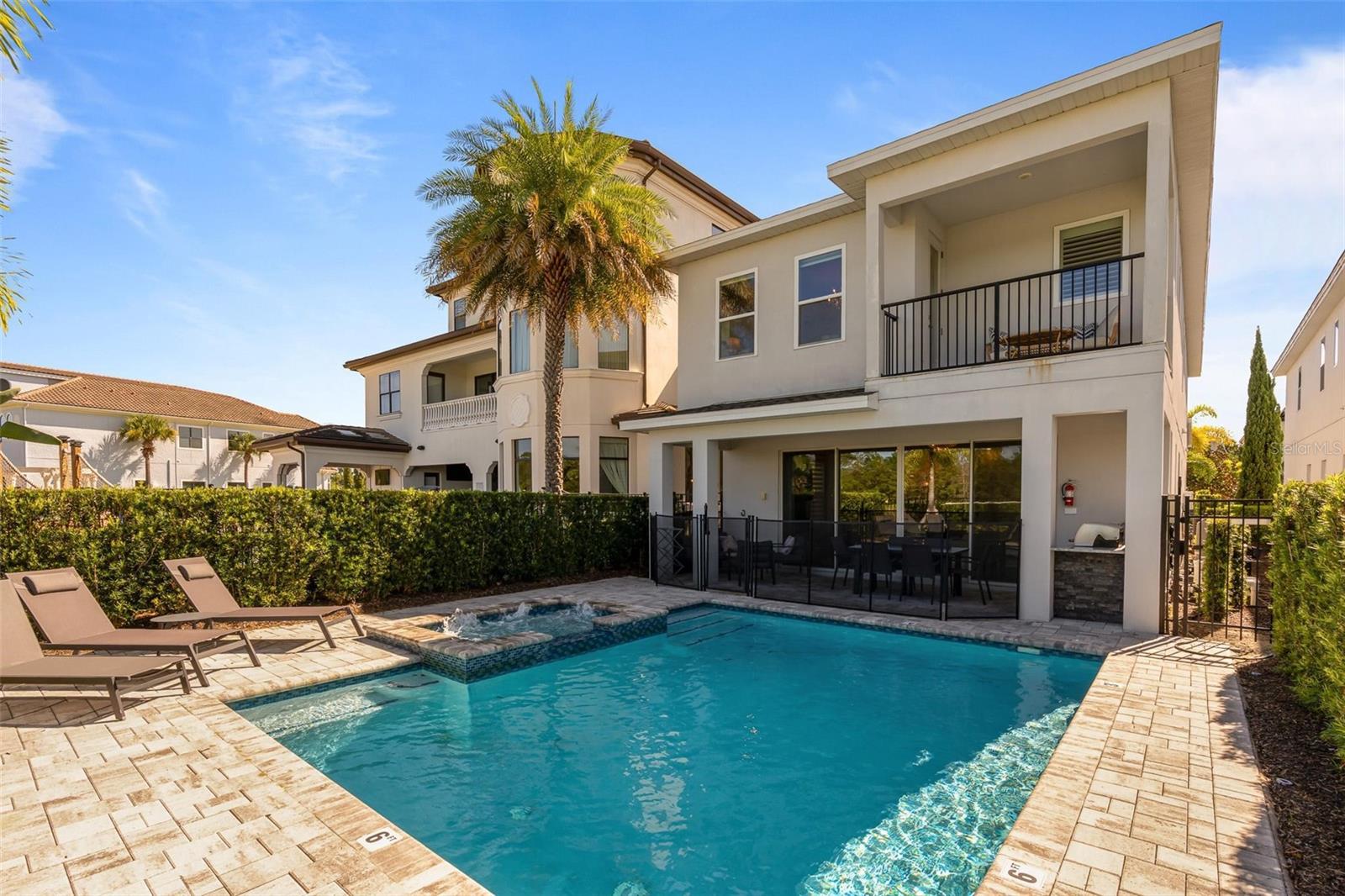Discover an extraordinary opportunity with this exquisitely styled and fully furnished home, complete with custom artwork and themed interiors. Currently benefiting from exceptional vacation rental bookings through the year, it’s a proven income generator, or the perfect full-time residence just minutes from Disney. Every detail in this home has been thoughtfully curated, with luxury upgrades and finishes that create a true sense of elegance. The open-concept living, dining, and kitchen areas are bright and welcoming, seamlessly flowing to the pool deck where you’ll find a summer kitchen and alfresco dining space. The spectacular pool, hot tub, and fire pit seating area enjoy panoramic southwest-facing golf course views. There are lavish master suites on both levels, each featuring crystal chandeliers, spa-inspired ensuites with double vanities, upgraded tile, and oversized showers and tubs. Upstairs, the master opens to a private balcony with sweeping golf course vistas, ideal for morning coffee or evening drinks. The loft offers space to relax with a pool table, TV, and coffee station, while the custom-designed game room features arcade favorites for all ages. Children and guests will be enchanted by the fully themed Princess and Hero bunk rooms, designed to bring vacation dreams to life. Best of all, this home comes with a transferable Gold Membership, granting access to Reunion’s three world-class championship golf courses, the expansive water park with lazy river, tennis courts, miniature golf, and the resort’s full array of amenities. Within the community, you’ll also find multiple dining options and a Starbucks. Just 7 miles from Disney, this property is the ultimate combination of luxury living and investment potential. Schedule your private viewing today.