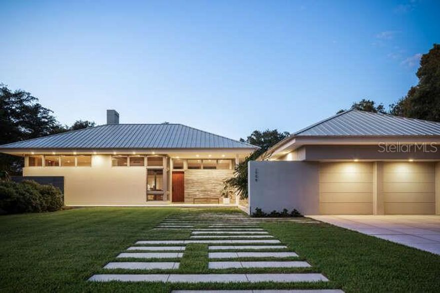 Situated on Cherokee Drive, perhaps the most coveted address in Sarasota on a gracious and grand parcel, this home was designed and constructed by two of Sarasota’s most revered and talented professionals. The flawless, clean design of award-winning architect, Guy Peterson, is paired with the incomparable quality, rarely seen in residential construction, carefully and thoughtfully achieved by Pat Ball.  Not only was no expense spared in the creation of this home, but the subtle tastefulness of its owners is apparent throughout. Cypress accent ceilings juxtaposed with santos mahogany wood floors, custom maple cabinetry, and board on board architectural molded concrete accent walls strike a natural harmonious balance with a sleek modern aesthetic. The intelligent U-shaped floor plan wraps itself around and perfectly frames the focal point of Petersons’ composition, a 45’ long, crystal clear swimming pool with spa. The green barrier surrounding the home creates the ultimate setting for tranquility and privacy. A stone pathway cuts a striking geometric pattern through the perfectly manicured front lawn up to the custom-made mahogany front door. Crossing the threshold, you enter a wide open living space that features a formal dining room and living room complete with a wood burning fireplace. The kitchen is impressively equipped with a Wolf double electric oven, six burner gas cooktop, Sub-zero refrigerator and ample storage. Floor to ceiling impact rated Marvin windows, transoms, and double doors allow natural light to pour in and creates a free-flowing indoor to outdoor entertainment space. The west wing of the home encompasses the spacious owner’s suite, as well as an executive scaled office. The walls of glass in the owner’s suite create a warm and inviting environment as you gaze out over the tranquil grounds. The east wing encompasses two en-suite guest rooms, both of which have their own private pool access through large sliding glass doors. The separate 500 sq ft guest cabana features a spacious living area, kitchenette and full en-suite bedroom. This peaceful, picturesque Cherokee Park neighborhood is well sought after for its beautiful oak-tree lined streets and the idyllic family friendly lifestyle. The neighborhood has an active voluntary Homeowners Association which organizes neighborhood social events during holidays and throughout the year. However, the biggest draw for this incredible community is its unparalleled location. It’s walking distance to the prestigious Southside School, minutes to Southside Village and downtown Sarasota, and only 5 streets from the North bridge to the world-famous white sands of Siesta Key Beach.