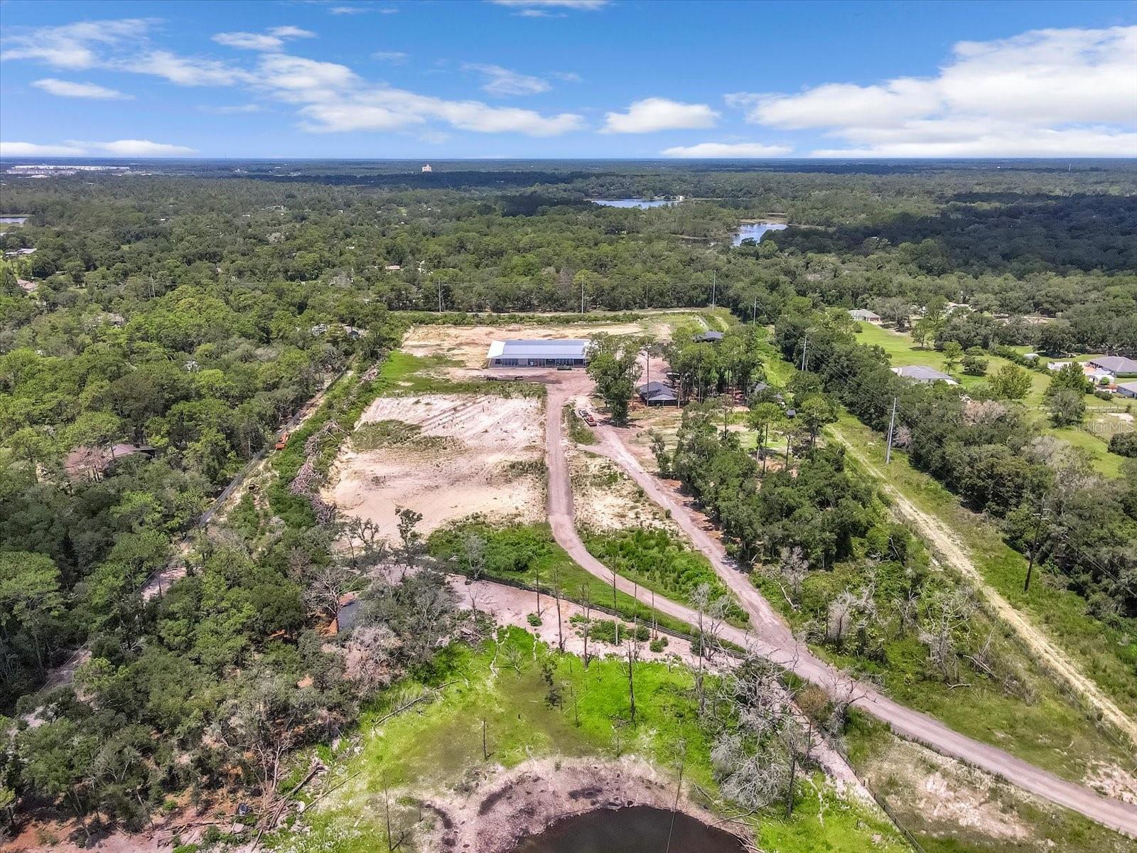 This remarkable 20.12-acre estate parcel is nestled in the peaceful countryside of Lake Helen, Florida. This expansive property is zoned for agricultural and rural residential use, offering a wide range of permitted uses including farming, equestrian activities, and the construction of a private estate. Whether you're seeking a tranquil homestead, an income-producing farm, or a development-ready site, this property provides the perfect foundation. At the heart of the land stands a massive 120x80 ft metal building—ideal for use as a workshop, storage facility, or future conversion into a barn-style residence. The property also features multiple pole barns, offering additional utility for agricultural equipment, livestock, or covered storage. With flat, open terrain and existing structures already in place, the groundwork is set for immediate use and development. Adding to the property’s exceptional value are included blueprints for a custom home exceeding 10,000 square feet. These professionally designed plans provide a head start for anyone looking to build a luxury estate, saving time and resources during the planning phase. With the zoning and infrastructure supporting large-scale residential development, the possibilities are extensive. Located just minutes from I-4 and within close reach of DeLand, Sanford, and the beaches, this secluded parcel offers both privacy and convenience. Don’t miss this rare opportunity to own a large, versatile tract of land in one of Volusia County’s most desirable rural communities.