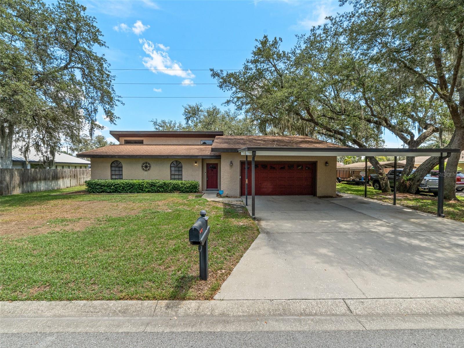 One or more photo(s) has been virtually staged. Welcome to this charming 3BR/2BA home tucked away on a quiet cul-de-sac in the established Homewood neighborhood of Winter Haven. Situated on a spacious .25-acre lot with no HOA, this steel-framed home offers comfort, durability, strength and freedom.
Step inside to find cathedral ceilings, an open floor plan, and a remodeled kitchen featuring granite countertops and updated cabinetry. French doors off the great room lead to a generous screened lanai, perfect for entertaining or enjoying the fully fenced backyard.
The oversized 2-car garage offers ample space for vehicles or a workshop area, with overhead storage—ideal for hobbyists or anyone in need of extra utility space. There’s also a large, covered carport for additional parking. The indoor laundry room is conveniently located just off the kitchen. The primary suite features a walk-in closet and private bath. A new roof was installed in 2020, and the home is constructed with durable steel studs for lasting peace of mind.
Located just 0.6 miles from Publix, and close to ALDI, Walmart, dining, and shopping. Enjoy easy access to SR 540, US 17, Polk Parkway, and I-4, making commuting to Lakeland, Tampa, or Orlando simple and efficient.
This well-maintained home blends practical features with thoughtful updates and a great location—schedule your showing today!