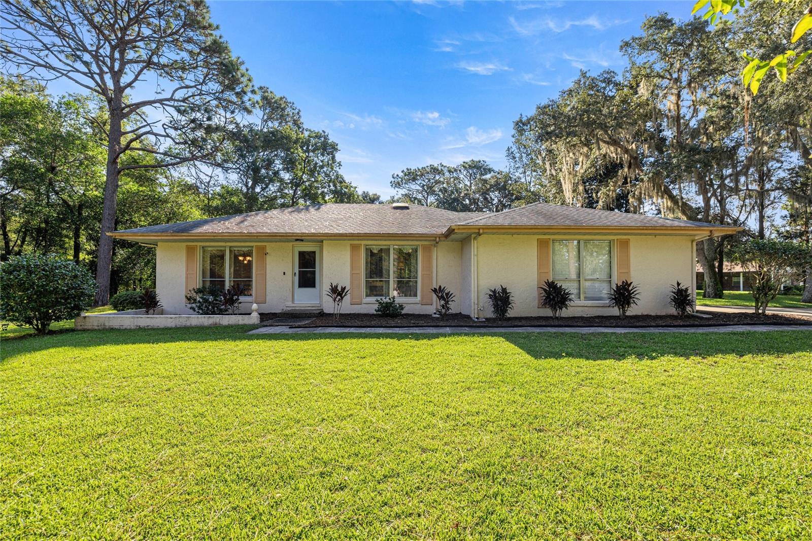 This charming 2/2 home may be modest in size, but it is filled with warmth, character, and thoughtful touches that make it truly special. Situated in the Woodlands of Rainbow Springs this home sits on 1.31 beautiful acres that is truly in a park like setting. The property offers a serene backdrop with majestic pines and mature oaks that perfectly complement the charm of the area. Inside, you’ll find bright living areas, a functional kitchen, comfortable bedrooms and a gas fireplace that adds warmth and comfort to the delightful space. The home is easy to maintain yet feels inviting and full of charm. Step outside and you’ll discover what makes this home shine — an amazing outdoor living space designed for both relaxation and entertaining. Start your mornings with a cup of coffee on the screened lanai, listening to the owls and songbirds while watching deer pass through the yard. After an enjoyable day in your yard, cool off with a refreshing dip in your 10x20 saltwater pool. The property also includes a long circle driveway for convenience and curb appeal, plus a garage with ample storage space. A few of the key factors include a new A/C 2023, a new pool pump 2023, a new drainfield 2022, a new bladder tank 2018, a new roof 2016 and a new well pump 2015. There is also a shed to store all of your lawn and pool equipment. Residents also enjoy some pretty sweet perks for a very low yearly HOA fee. They include community swimming pool, clubhouse, bocce ball, pickle ball, tennis, basketball, driving range, restaurant, disc golf, walking trail and access to your own private 3-acre residents park which offers a short peaceful kayak or canoe paddle to the first magnitude Rainbow River State Park head spring. This exclusive community river park has 2 large pavilions, barbecue grills, segregated bathrooms, outdoor showers, private swimming area, kayak launch and supervised security for safety and peace of mind. Dunnellon’s Rainbow Springs is a rare gem. You will also be able to experience world class golf just next door at Juliette Falls Country Club. This ideal location places you at the doorstep of small town living at its finest in addition to being close to Ocala, Gainesville and vacation attractions found in nearby Tampa and Orlando. Don't miss your opportunity to visit this lovely home and property. Whether you’re a first-time homebuyer, downsizing, or looking for a seasonal retreat, this home is a perfect fit and offers the comfort of cozy indoor living paired with exceptional outdoor space.