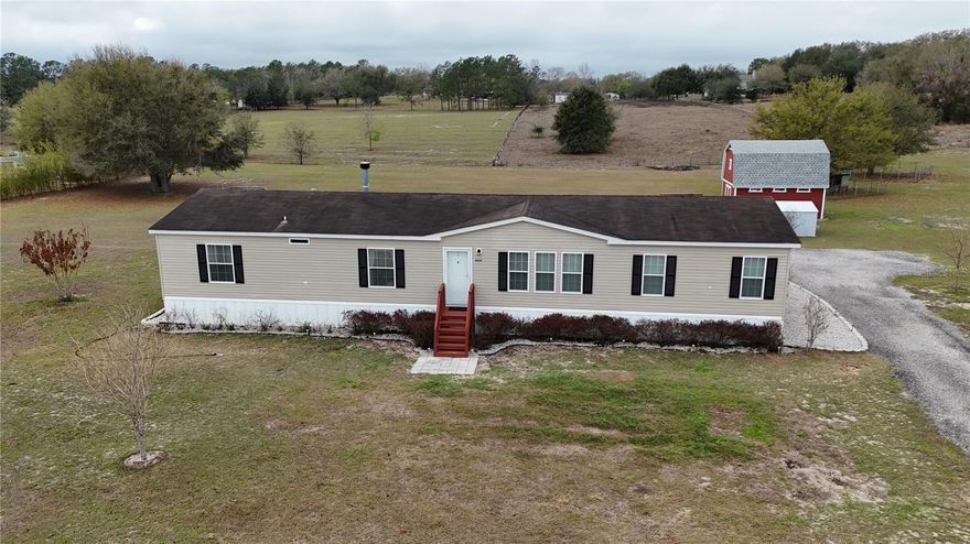 Turnkey, move-in ready beautiful home on 2.26 acres of pure beauty! Located minutes from major highways, hospitals, golf courses, trails, lakes, boat ramps, shopping and more. This spacious and comfortable home offers 3 bedrooms plus an office with a walk-in closet that can easily be used as a 4th bedroom, 3 full baths, and over 2,000 sq ft of living space. When you enter, you are welcomed by an elegant open-concept floor plan featuring a beautiful tray ceiling that adds architectural charm and a grand feel—perfect for entertaining. The large kitchen offers plenty of cabinets, a walk-in pantry, and a spacious island overlooking the living areas, so you can cook and still be part of the conversation. Enjoy a cozy wood-burning fireplace during Florida’s cooler nights. The oversized primary suite provides plenty of room for all your furniture plus a sitting area. The primary bath features double vanities, a large walk-in shower, and a walk-in closet. The secondary bedrooms share a convenient Jack and Jill full bathroom, and the home also includes a third full guest bathroom for added comfort and convenience. Step outside to your private paradise featuring a large firepit over a beautiful, paved patio—perfect for gatherings under the stars—as well as an additional wood deck patio ideal for relaxing or entertaining. The property also includes a 20x15 two-story barn ideal for a workshop, storage, hobby space, or whatever you can imagine, plus an additional shed and chicken/duck coop. With a well and filtration and purification system, saying goodbye to expensive water bills. Bring your horses, RV, boats, and all your toys! Centrally located just minutes from Lake Harris, downtown Clermont, downtown Tavares, Mission Inn Resort & Club, and JB Boondock's Bar & Grill located on Little Lake Harris. This property truly has it all. Schedule your private showing today before it’s gone!