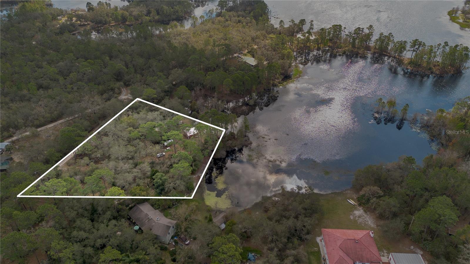 LOCATION, LOCATION, LOCATION - Build your custom LAKEFRONT dream home on your very own private oasis! With over 3 acres of land, grand fathered barn with power and panoramic views of Lake Bulter Chain this beautiful property offers a tranquil setting with sunset views. Current zoning allows for 1 horse per 1 acre. Enjoy the ranch style living, just minutes away from shopping, easy accessibility to major highways, airport and East Coast beaches. True Florida living awaits. Survey available. Schedule your private showing today!