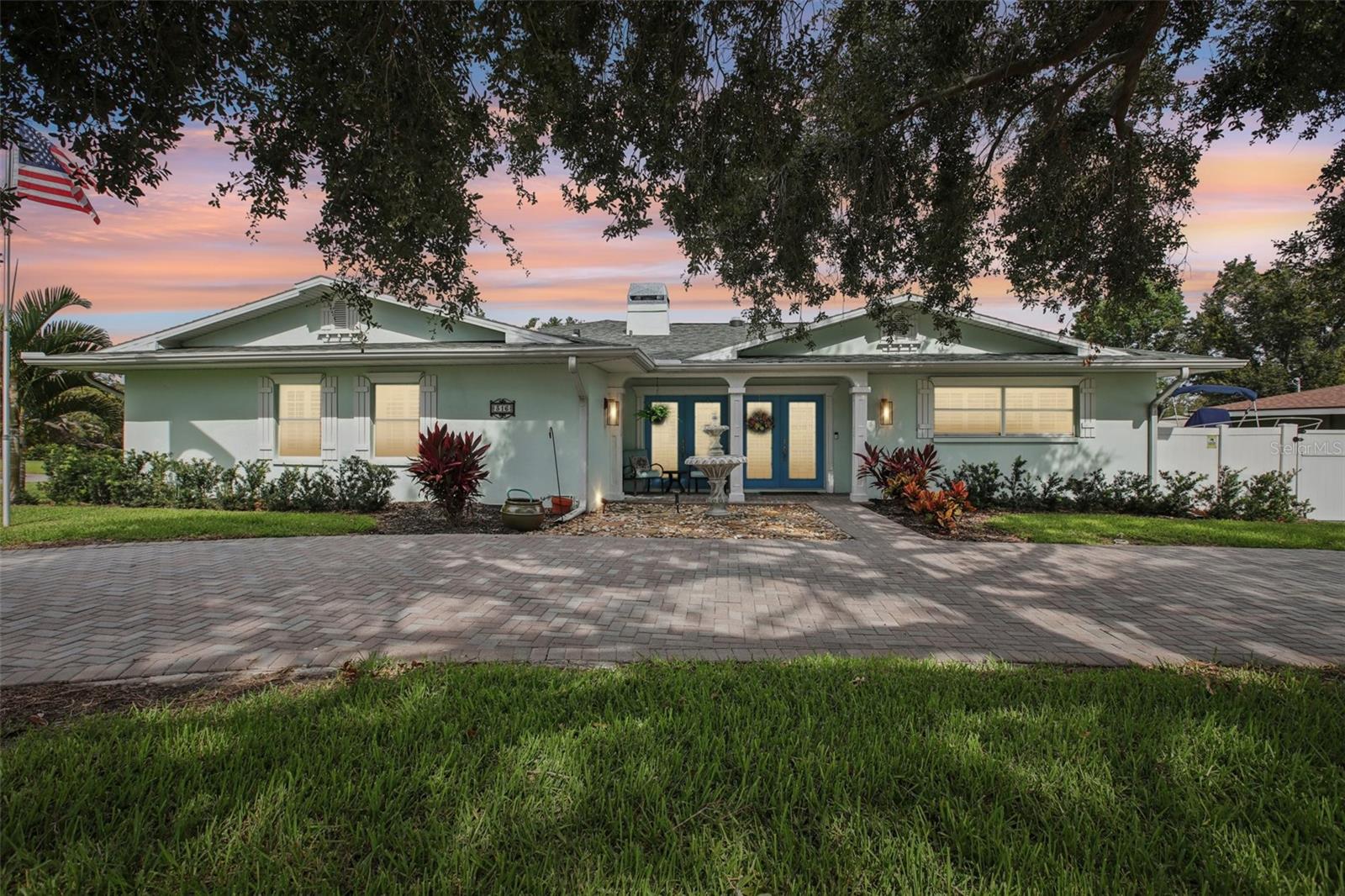 Under contract-accepting backup offers. Exquisite POOL Home nestled on a CORNER LOT in the highly desired neighborhood of Harbor Bluffs. Now this home TRULY does have it ALL and in a NON-FLOOD ZONE. A bundled service pricing available for buyers. Connect with the listing agent for details. From the lovely curb appeal of the paved circular driveway you enter into a dream. This light and bright vision – made possible with 5 solar tubes – comprises custom woodwork throughout with bookcases, wrapped columns, coffered ceilings and Plantation Shutters to set the elegant tone of this 6 bedroom, 4 full bath, 3 car garage home. Other key features are surround sound, newer lighting and easy maintenance with newer Porcelain floors throughout the living area. The floorplan is a well-designed and unique SPLIT-PLAN providing the ultimate in privacy. The entry presents a cozy sitting area with a working fireplace. On the right side you have two guest bedrooms separated by a full bath with the back bedroom having an ensuite full bath perfect for those extended guest stays. On the other side is the Primary RETREAT that features a spacious room with walk-in closet and a spa-like Primary bathroom with oversized shower, dual sinks, dedicated vanity, and a marvelous Cielo Whirlpool soaking tub to relax in, all this with newer granite counters and tile. Next to the Primary is a Bedroom ideal to use as an office. The ease of entertaining in this home is NEXT LEVEL, from the dedicated dining room on the upper level that flows into the kitchen which is open to the living room. The remodeled kitchen is a chef’s dream with a Peninsula that seats 6+ guests to conduct your own cooking show with the high-end Stainless-Steel appliances featuring a split-oven with convection cooking. There is plenty of storage in the solid wood Craftsman cabinets and large pantry with custom pull-out shelves – and two more refrigerators in the 3 car garage for the big events! In the back area of this wing are the remaining two guest rooms and full bath. The living space connects to FUN in the Florida room spilling out to the fabulous and newly resurfaced pool area with Travertine Decking and SCREENED LANAI surrounded with lush Palms for your PRIVATE Tropical OASIS where the parties never end, especially with a BRAND NEW POOL HEATER for the winter months! Outside the Lanai is a BBQ Pad as well as room for your water toys…told you it really does have it all! AND just around the corner from delicious restaurants at The Plaza, three blocks from the water and just five minutes to sugar sand beaches. So many features and additions, please see attached list, Roof 2017; HVAC (2) 2018; HWH (2) 2021, irrigation system (3 wells,pump,WiFi Controller) 2022. Don’t miss your chance to own this sophisticated, practical and entertaining beauty of a home!