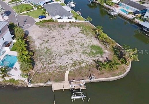 Don’t miss this rare opportunity to build your perfect Florida dream home on this sprawling waterfront lot. This rare opportunity is for that special buyer searching for the ultimate waterfront property to build an extraordinary home with panoramic views of protected deep Waterway. Located at the end of a quiet cul-de-sac in the Harbor Hills deed restricted community, this lot has 249 feet of protected deep water frontage that is positioned to allow for mesmerizing panoramic views and plenty of room for a large boat or multiple boats that offers protection from boat traffic within a zero wake zone. Enjoyed access to the beautiful Intracoastal Waterways and the Gulf of Mexico makes this location a boater’s dream. A boat dock, wave runner lift and boat lift are already in place. A conveniently location on the mainland without having to fight the beach traffic, yet minutes to shopping, restaurants, shopping, the white sandy beaches and a short drive to two airports.